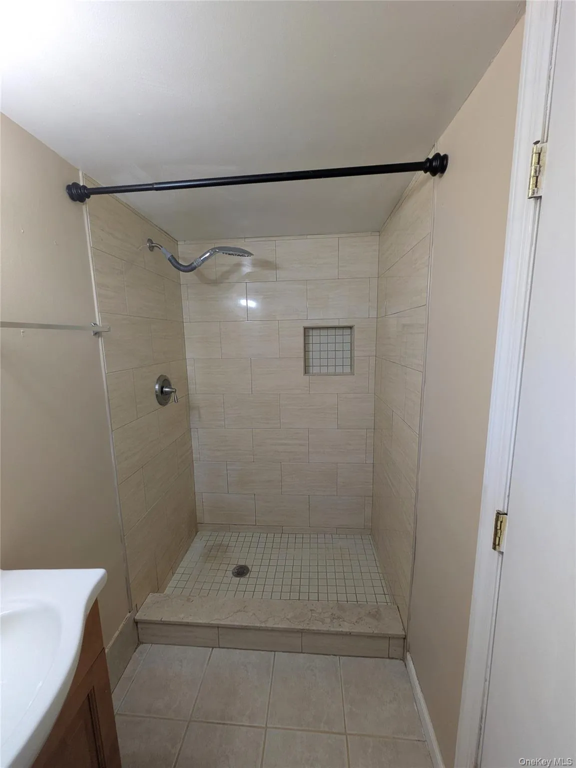 Full bathroom featuring a stall shower, light tile patterned flooring, and vanity Full bathroom featuring a stall shower, light tile patterned flooring, and vanity