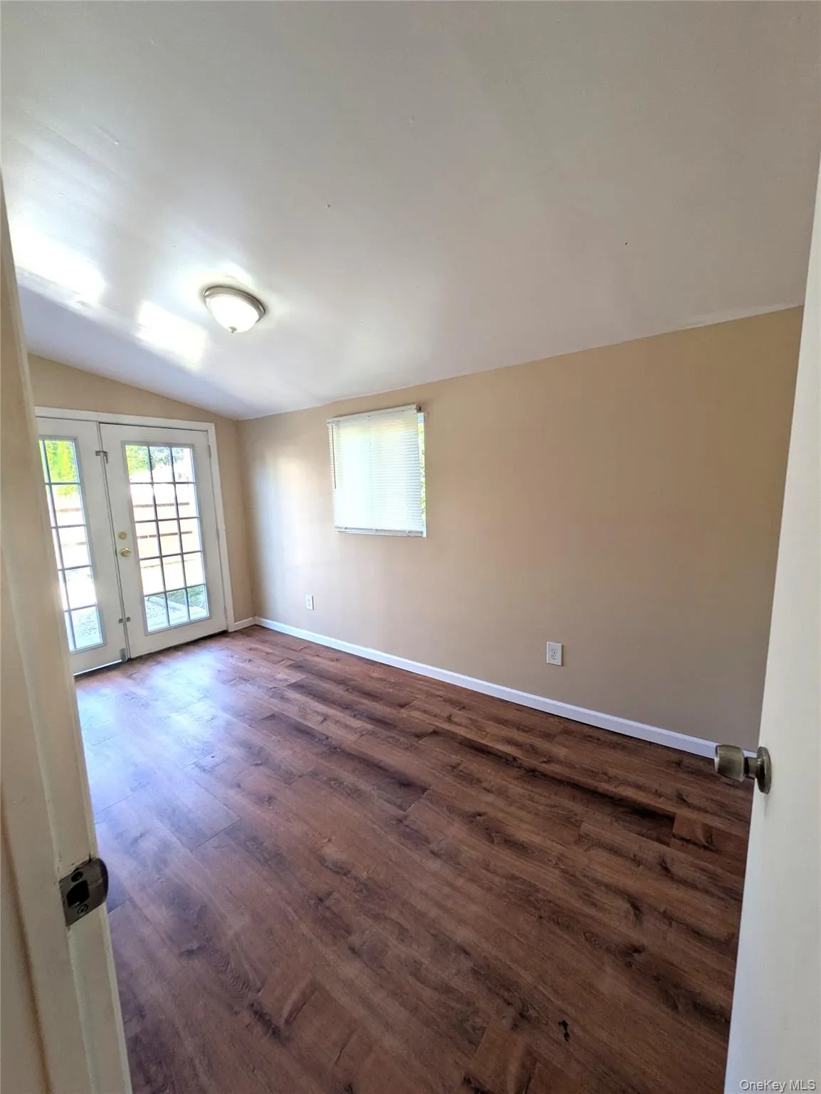 3rd bedroom with dark wood finished floors and vaulted ceiling. 3rd bedroom with dark wood finished floors and vaulted ceiling.