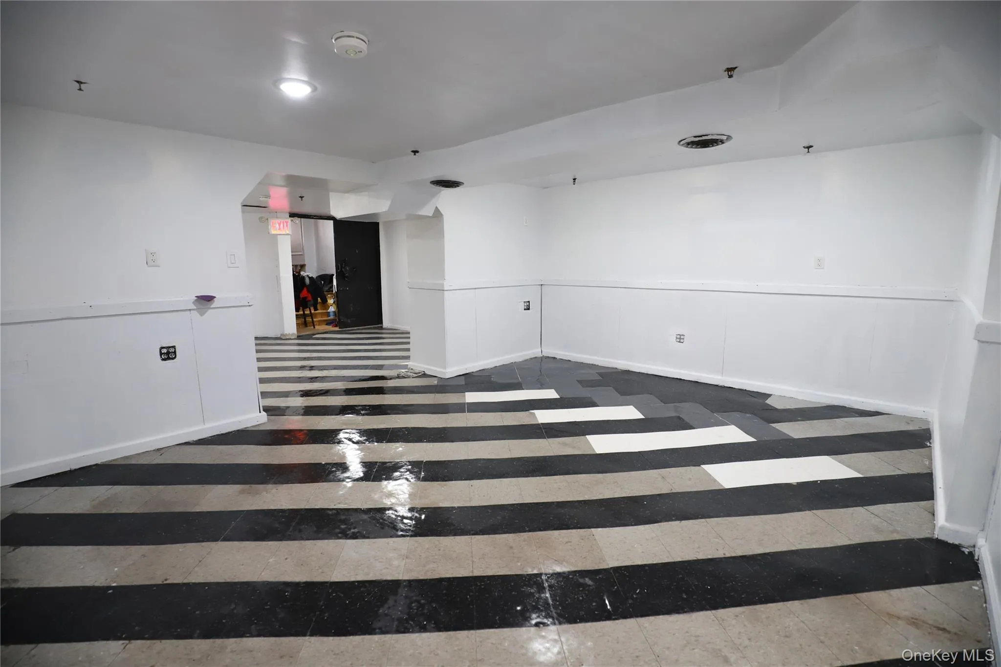 Spare room with wainscoting and inlaid floor details Spare room with wainscoting and inlaid floor details