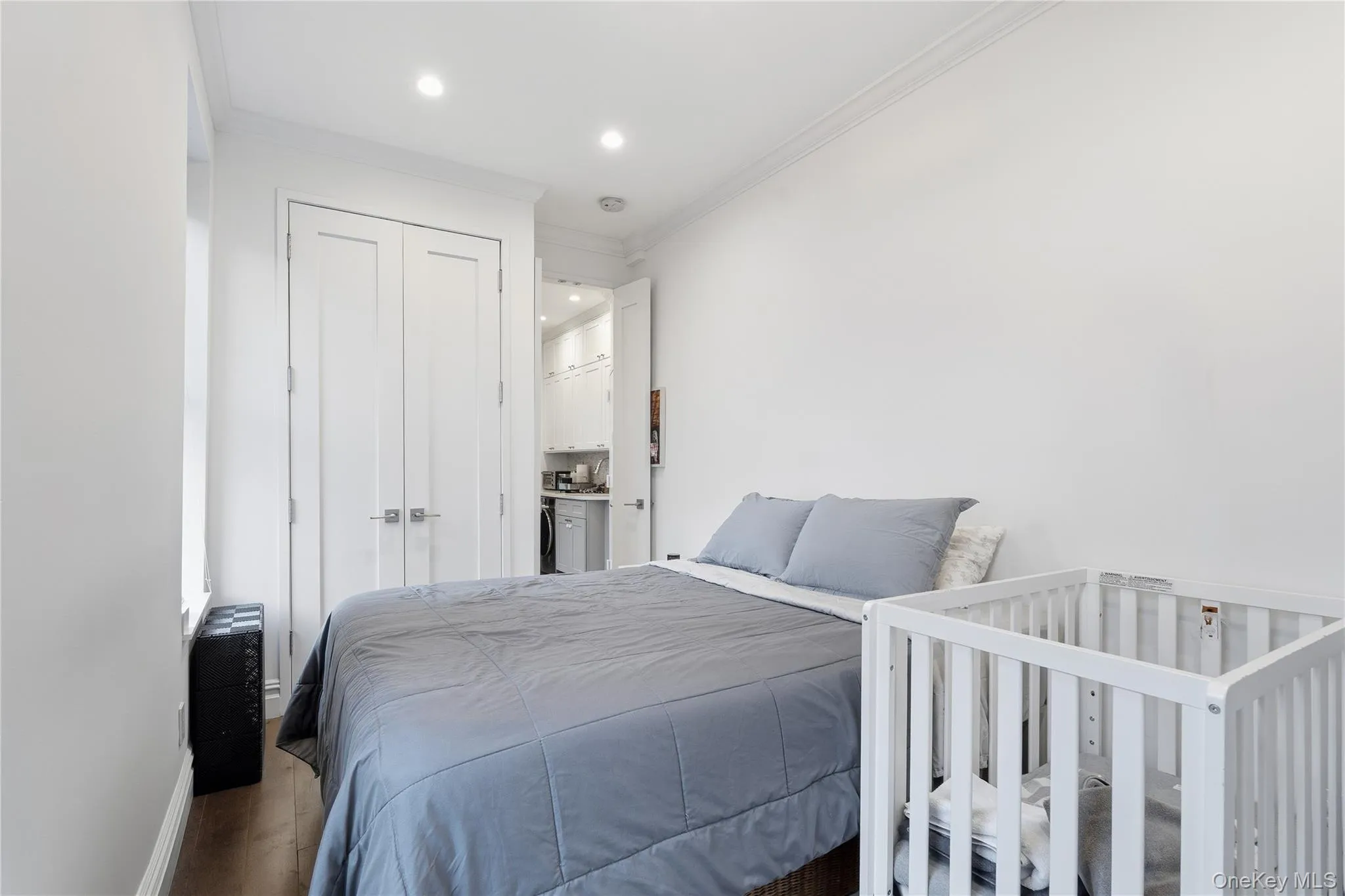 Bedroom with crown molding, a closet, wood finished floors, recessed lighting, and connected bathroom Bedroom with crown molding, a closet, wood finished floors, recessed lighting, and connected bathroom