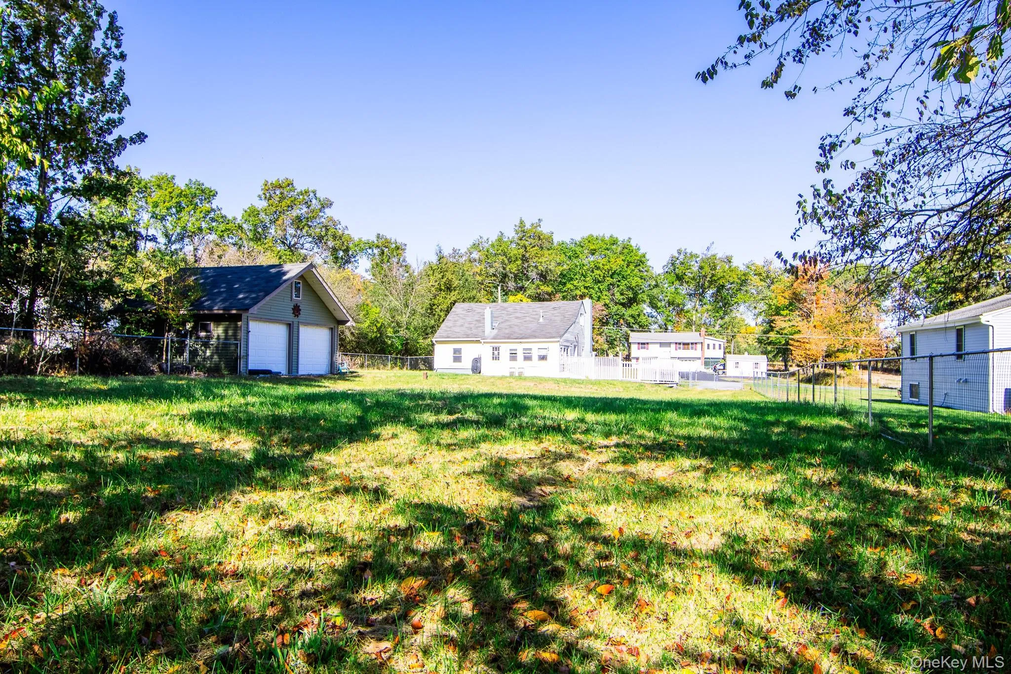 Fenced backyard featuring view of scattered trees Fenced backyard featuring view of scattered trees