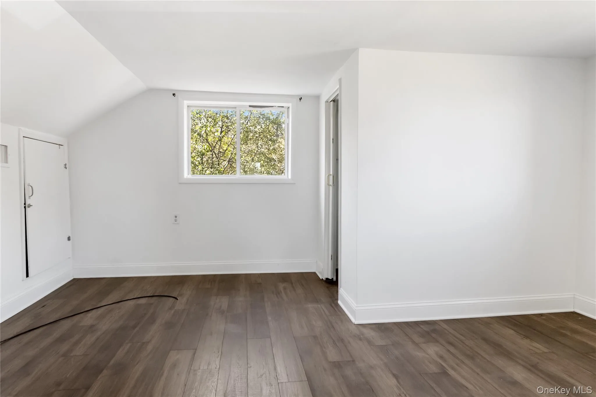 Bonus room with dark wood-style flooring and lofted ceiling Bonus room with dark wood-style flooring and lofted ceiling