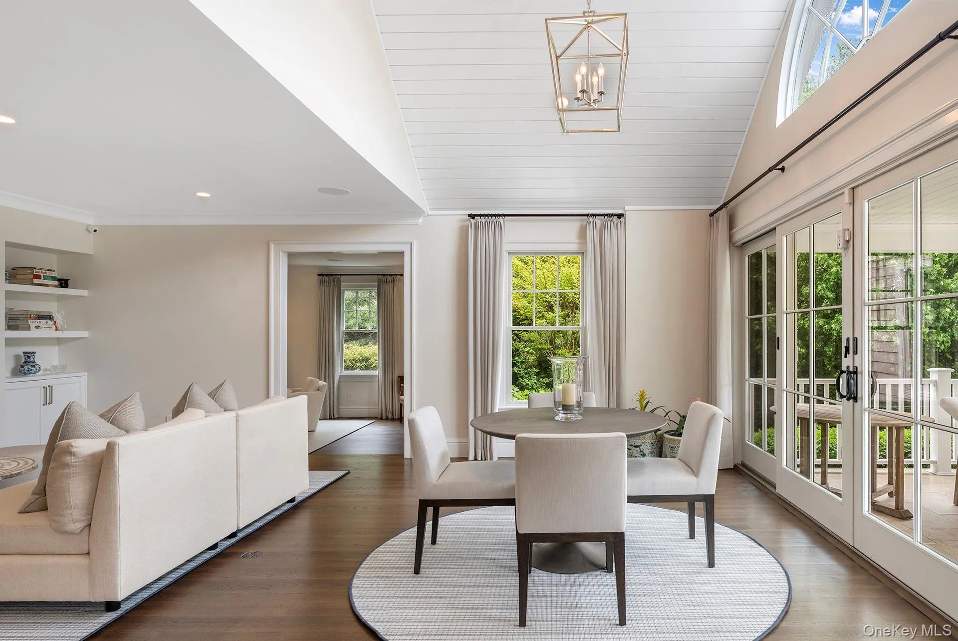 Dining space with vaulted ceiling, wood finished floors, french doors, a chandelier, and wood ceiling Dining space with vaulted ceiling, wood finished floors, french doors, a chandelier, and wood ceiling