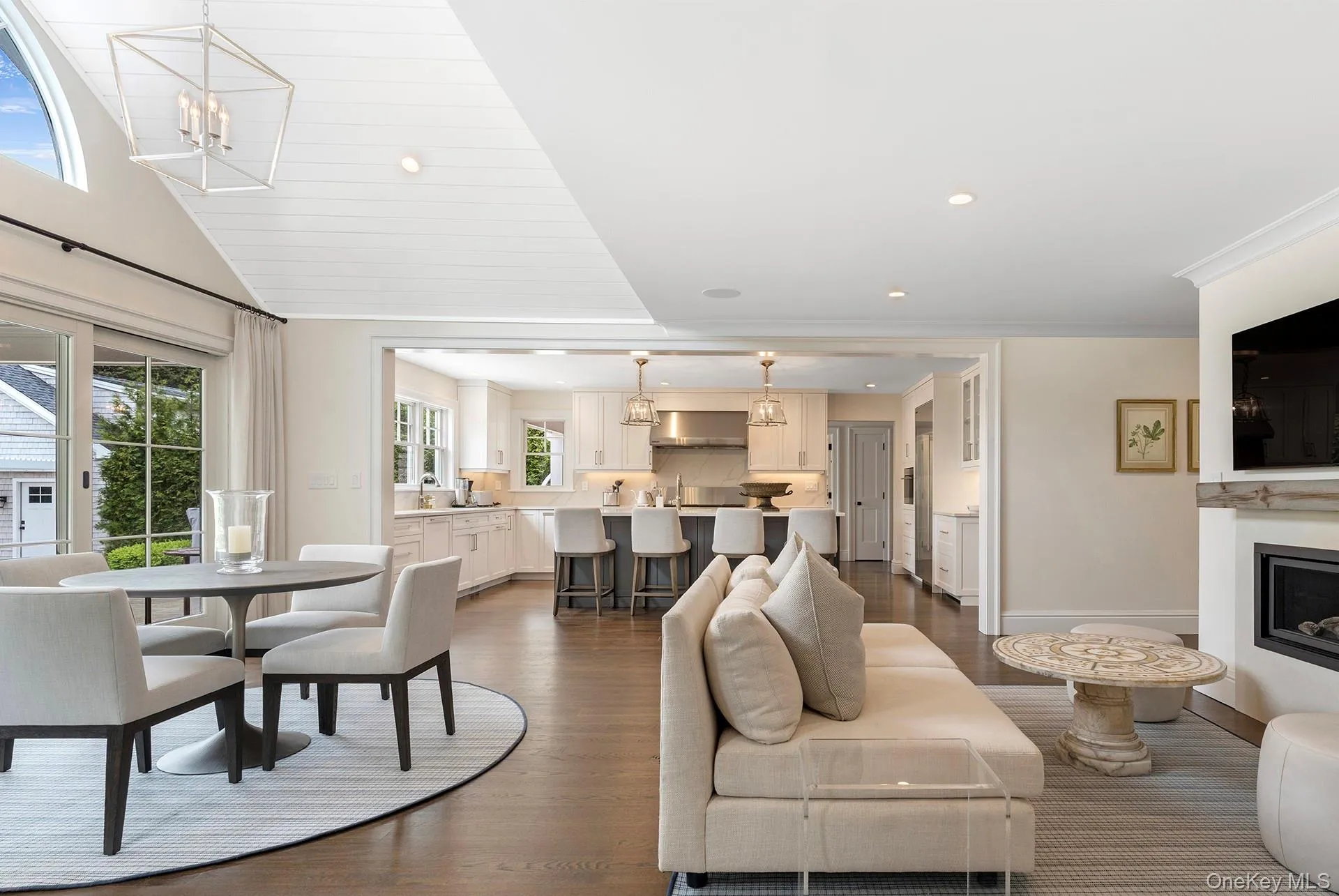 Living room with dark wood-style flooring, a chandelier, recessed lighting, a fireplace, and lofted ceiling Living room with dark wood-style flooring, a chandelier, recessed lighting, a fireplace, and lofted ceiling