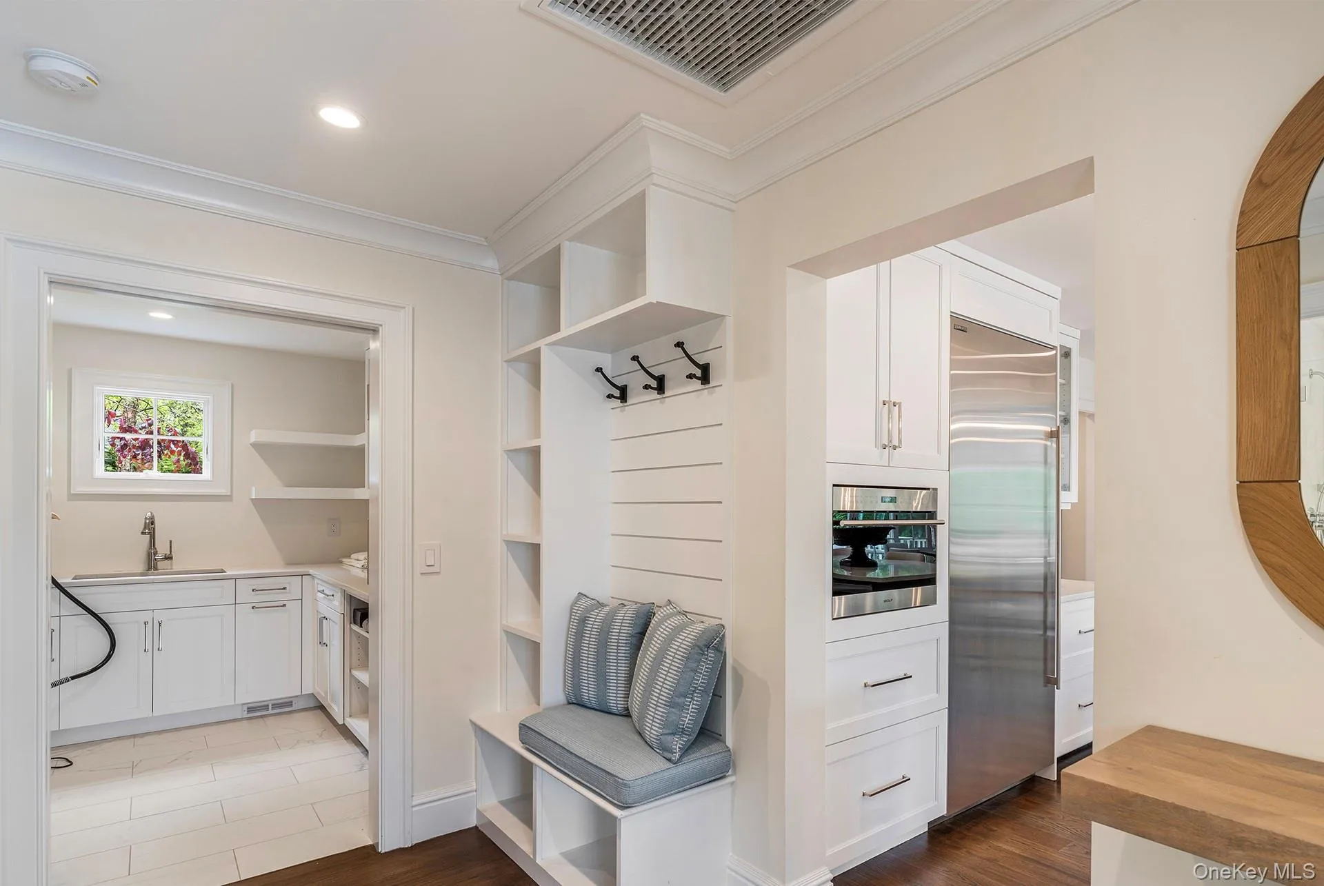 Mudroom with ornamental molding, dark wood-style flooring, and recessed lighting Mudroom with ornamental molding, dark wood-style flooring, and recessed lighting