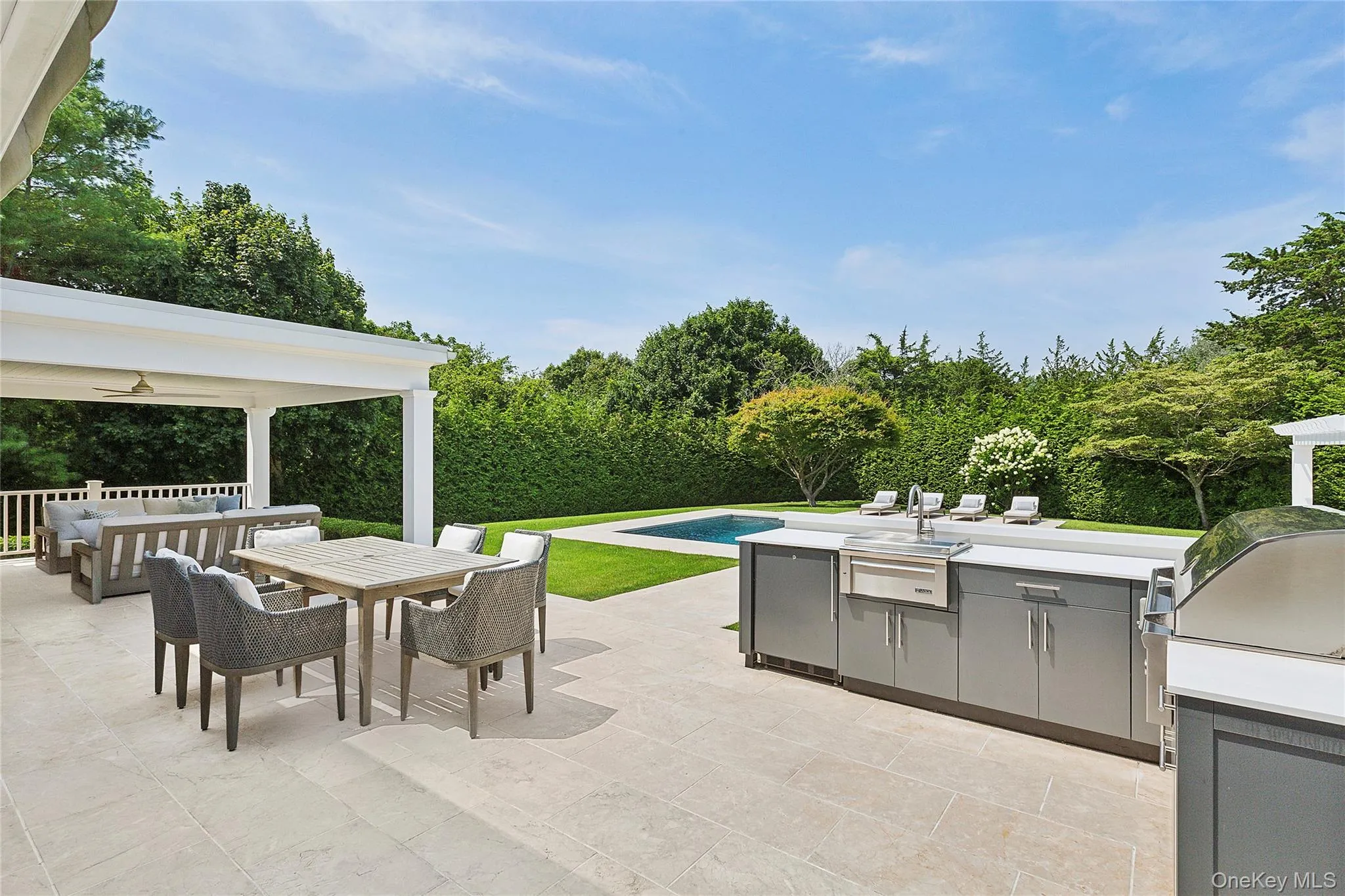 View of patio / terrace with outdoor dining space, area for grilling, and view of scattered trees View of patio / terrace with outdoor dining space, area for grilling, and view of scattered trees