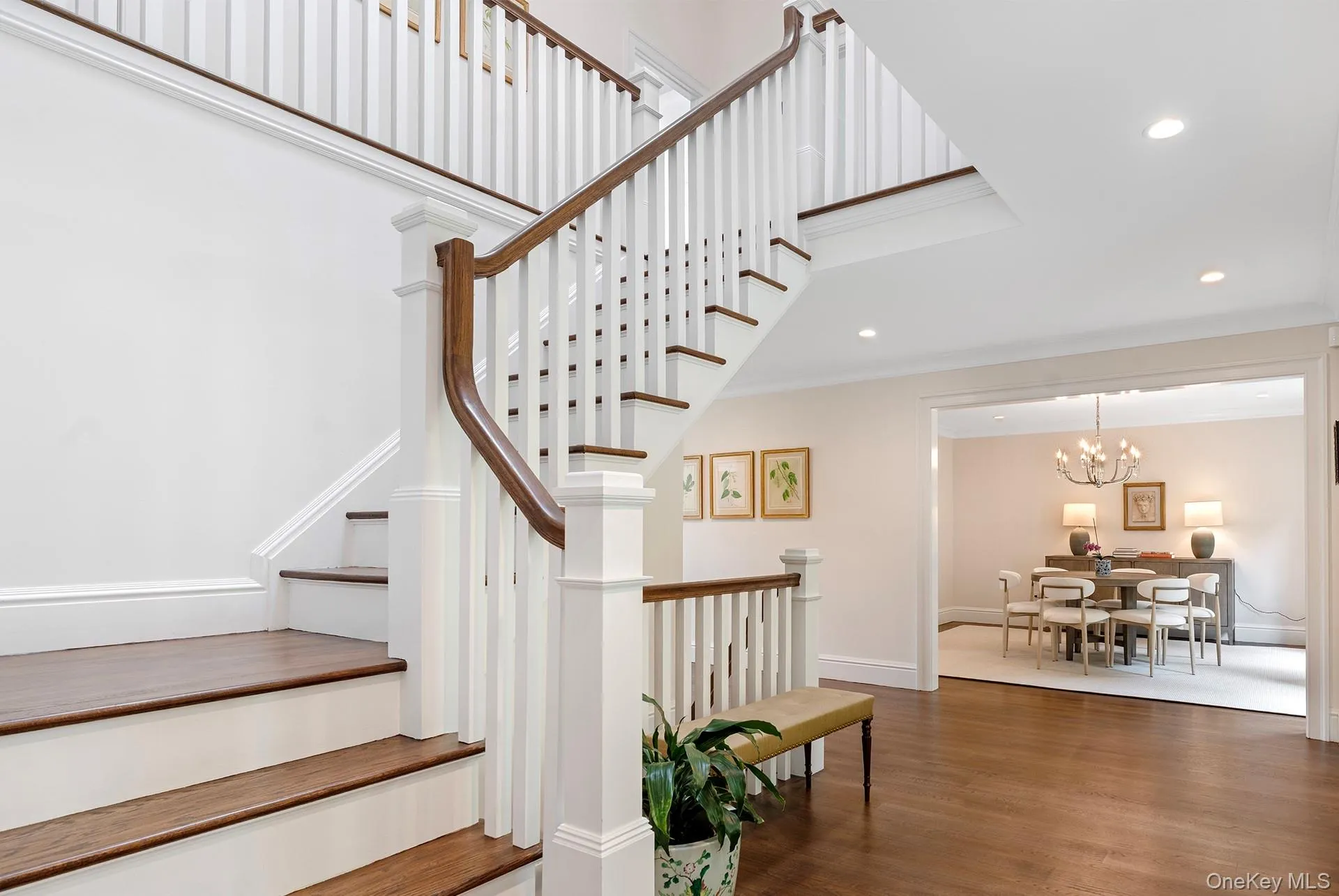 Stairs featuring wood finished floors, recessed lighting, crown molding, and a chandelier Stairs featuring wood finished floors, recessed lighting, crown molding, and a chandelier