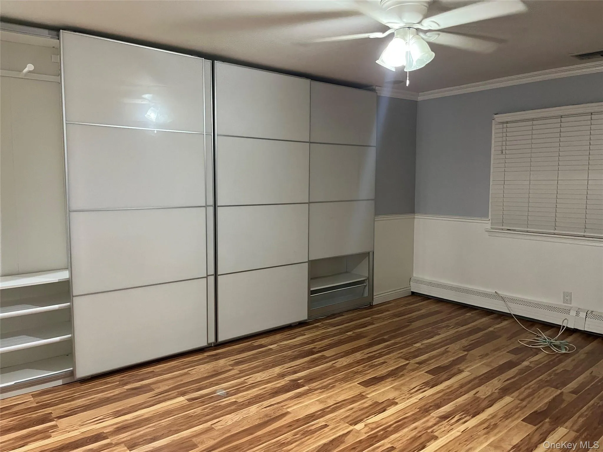 Unfurnished bedroom featuring light wood-style floors, crown molding, and ceiling fan Unfurnished bedroom featuring light wood-style floors, crown molding, and ceiling fan