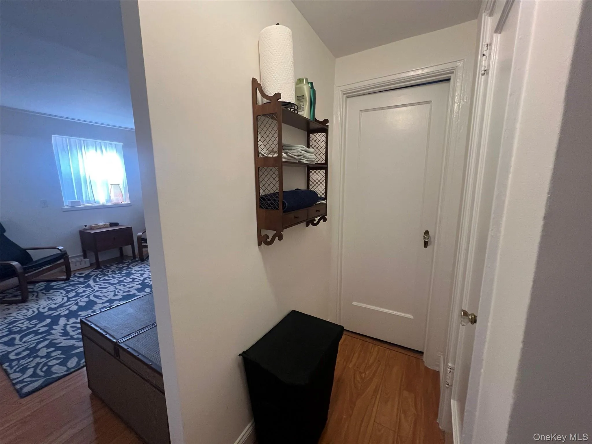 Hallway with wood finished floors and baseboards Hallway with wood finished floors and baseboards