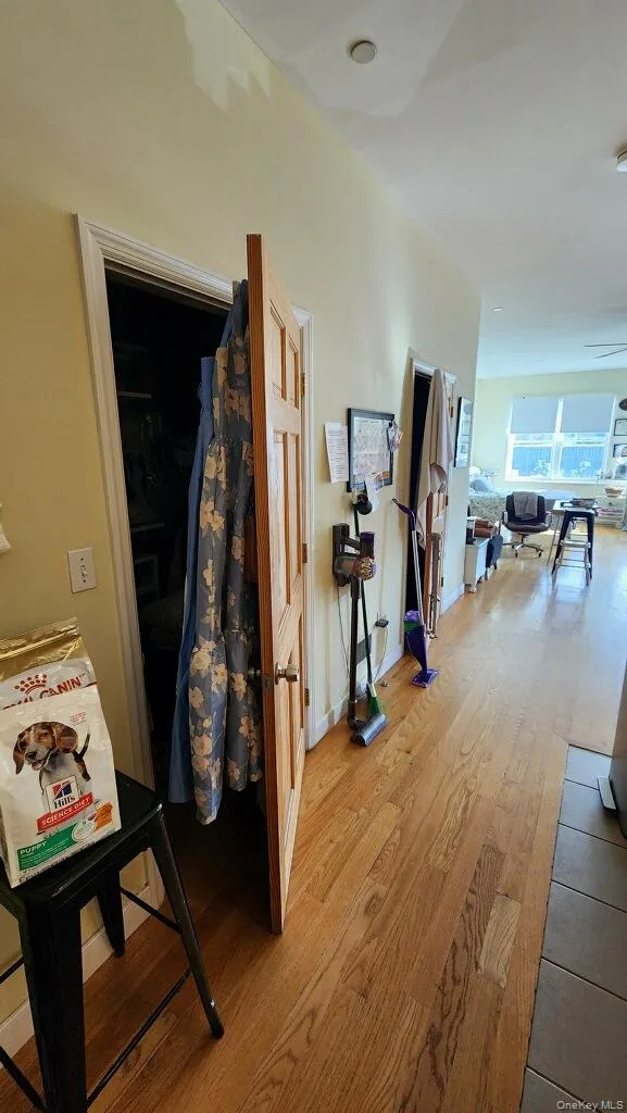Hall with wood finished floors and baseboards Hall with wood finished floors and baseboards