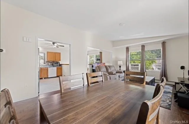 Dining space featuring dark wood-style flooring and ceiling fan Dining space featuring dark wood-style flooring and ceiling fan