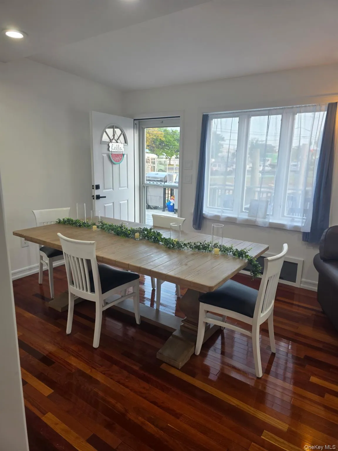 Dining space with dark wood-type flooring and recessed lighting Dining space with dark wood-type flooring and recessed lighting