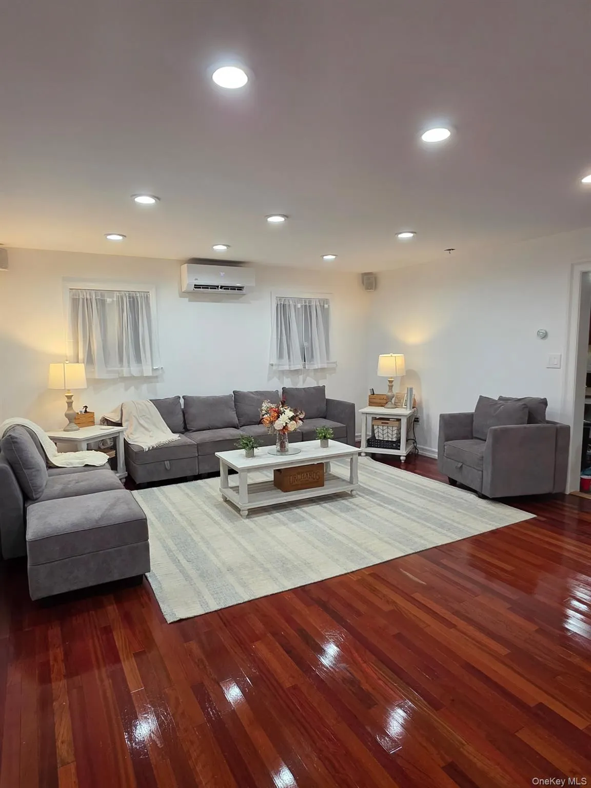 Living room featuring hardwood / wood-style floors and recessed lighting Living room featuring hardwood / wood-style floors and recessed lighting