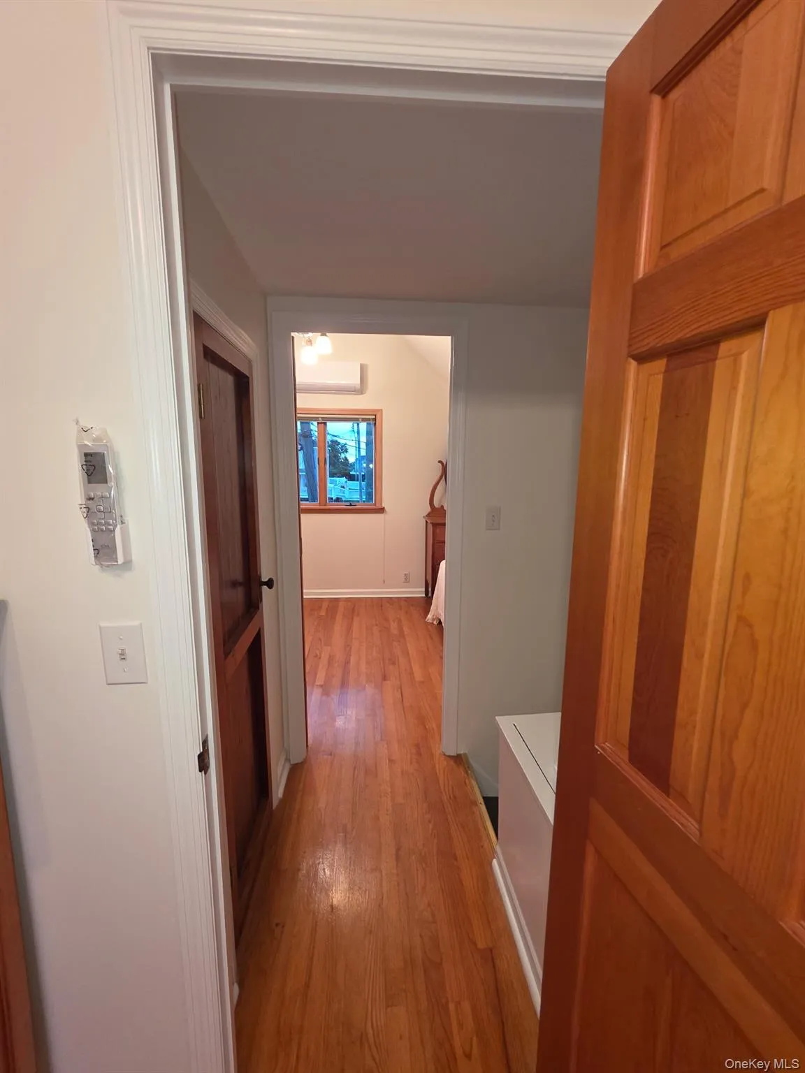 Hallway with light wood finished floors and baseboards Hallway with light wood finished floors and baseboards