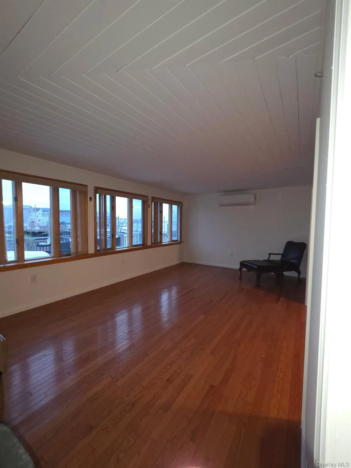 Unfurnished living room featuring hardwood / wood-style floors and wooden ceiling Unfurnished living room featuring hardwood / wood-style floors and wooden ceiling