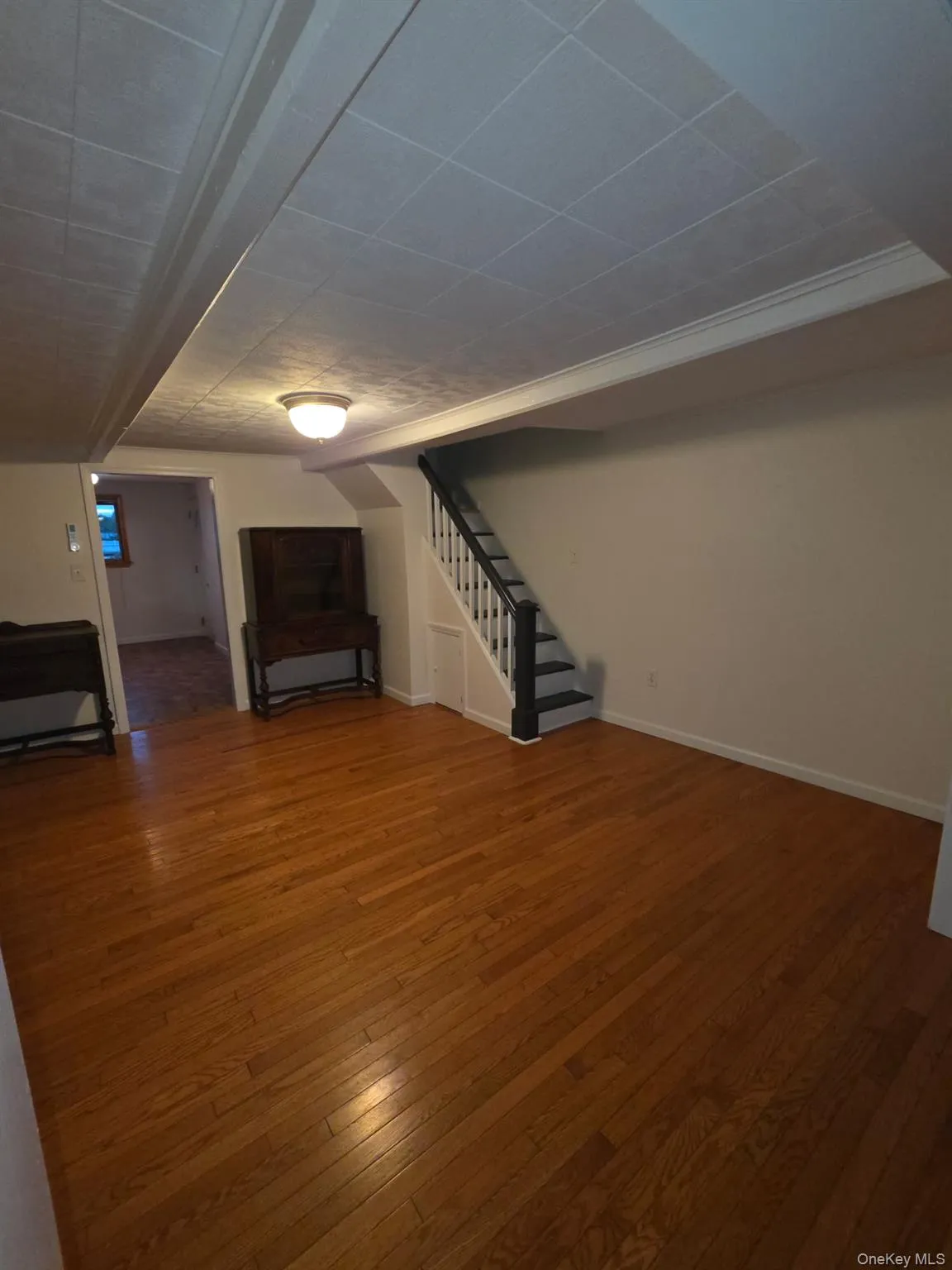 Basement featuring stairs and wood-type flooring Basement featuring stairs and wood-type flooring