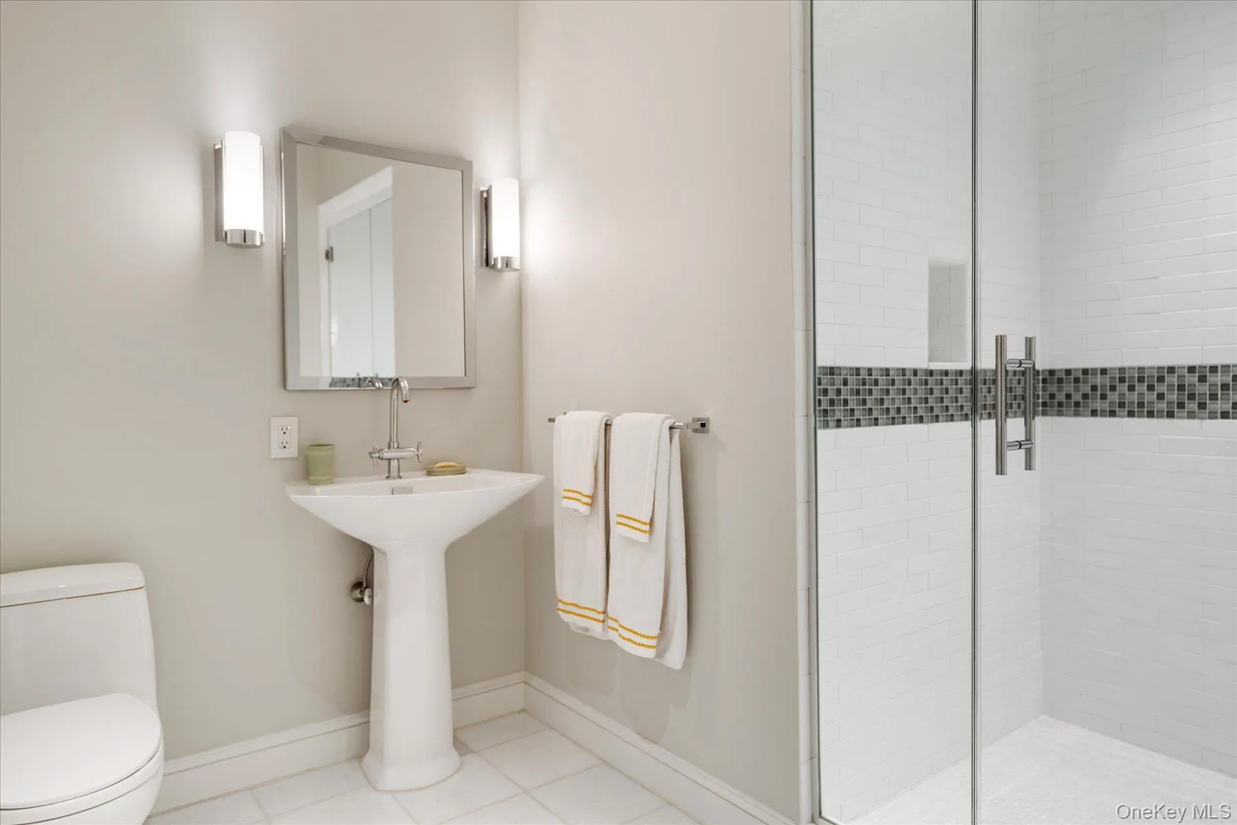 Bathroom with light tile patterned flooring and a shower stall Bathroom with light tile patterned flooring and a shower stall