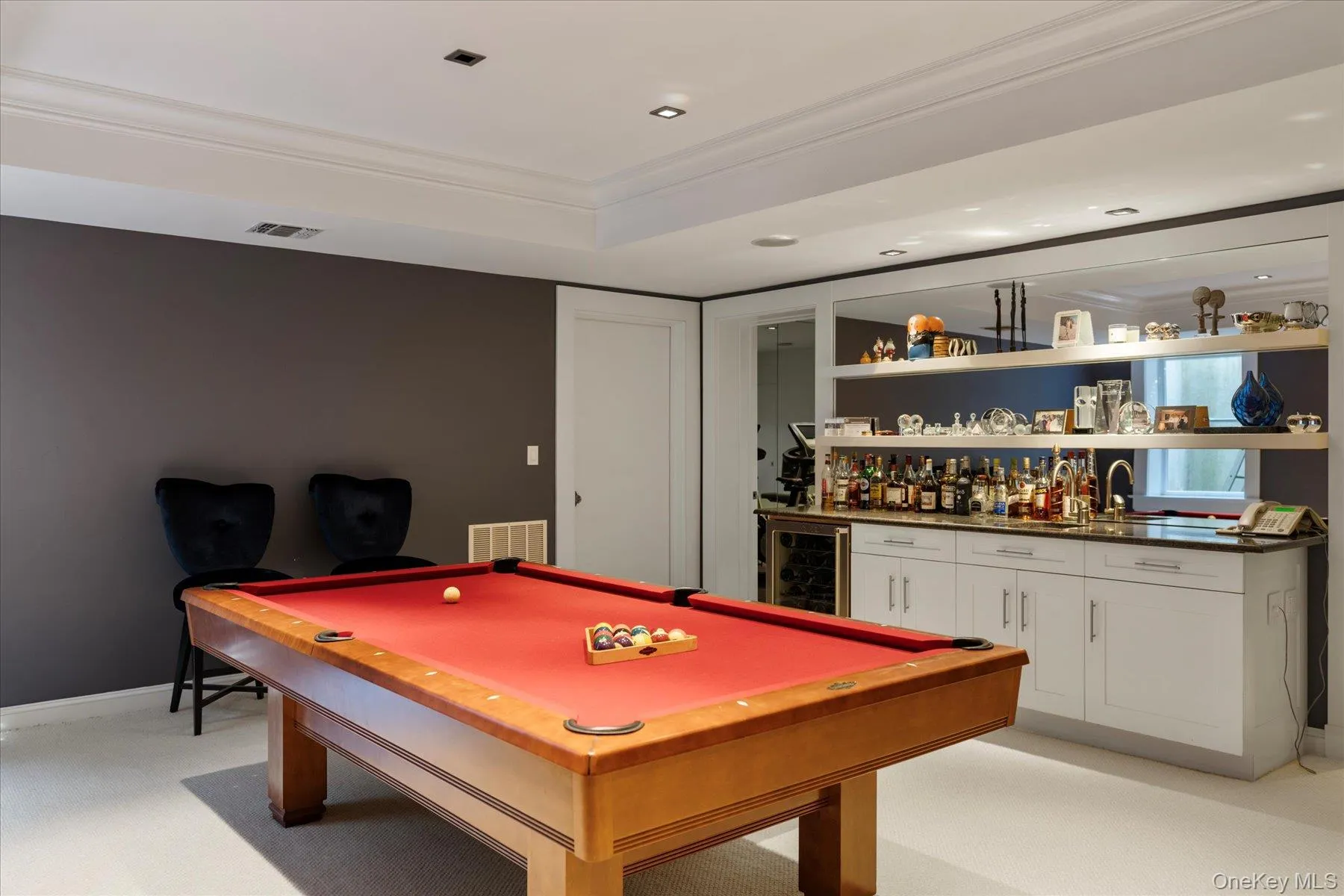 Recreation room featuring crown molding, light carpet, wet bar, beverage cooler, and pool table Recreation room featuring crown molding, light carpet, wet bar, beverage cooler, and pool table