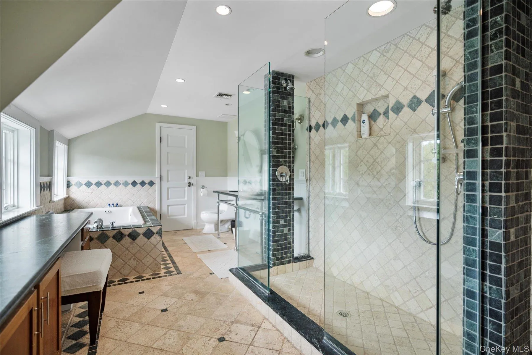 Bathroom with a garden tub, a shower stall, wainscoting, recessed lighting, and tile walls Bathroom with a garden tub, a shower stall, wainscoting, recessed lighting, and tile walls