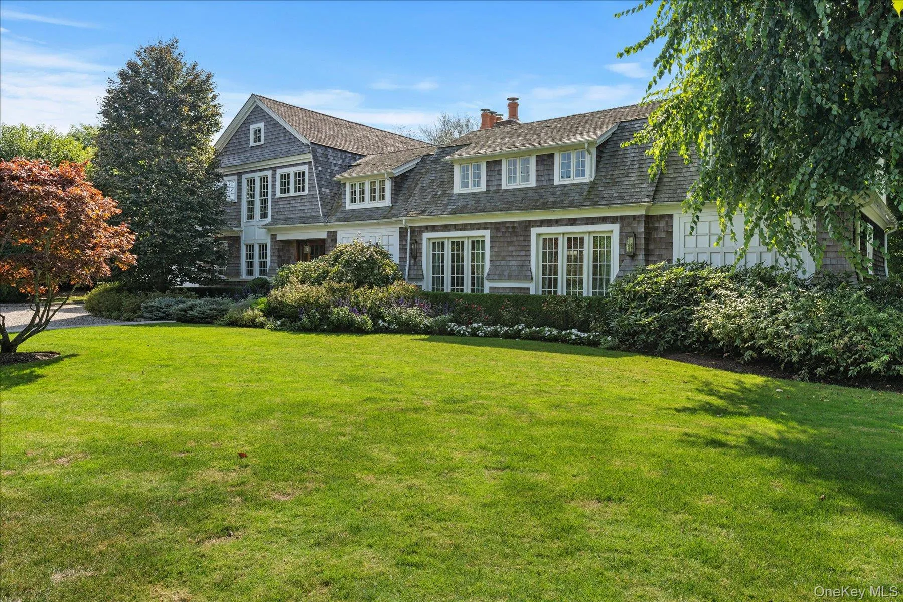 View of front of home featuring a front lawn and a chimney View of front of home featuring a front lawn and a chimney