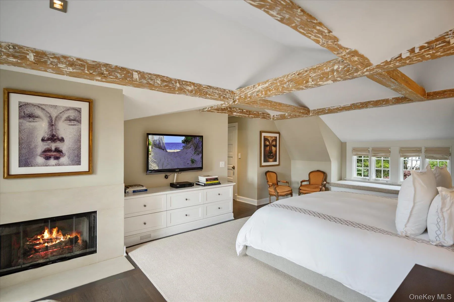 Bedroom with dark wood-type flooring and a fireplace with flush hearth Bedroom with dark wood-type flooring and a fireplace with flush hearth