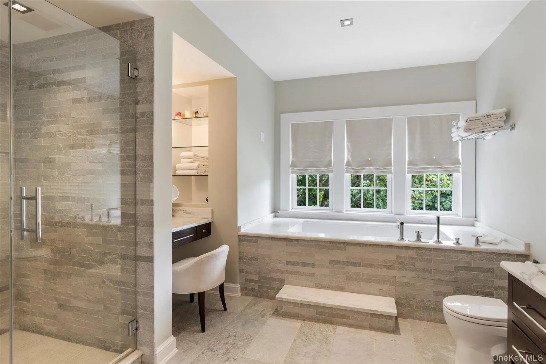 Full bath featuring vanity, a shower stall, and a bath Full bath featuring vanity, a shower stall, and a bath