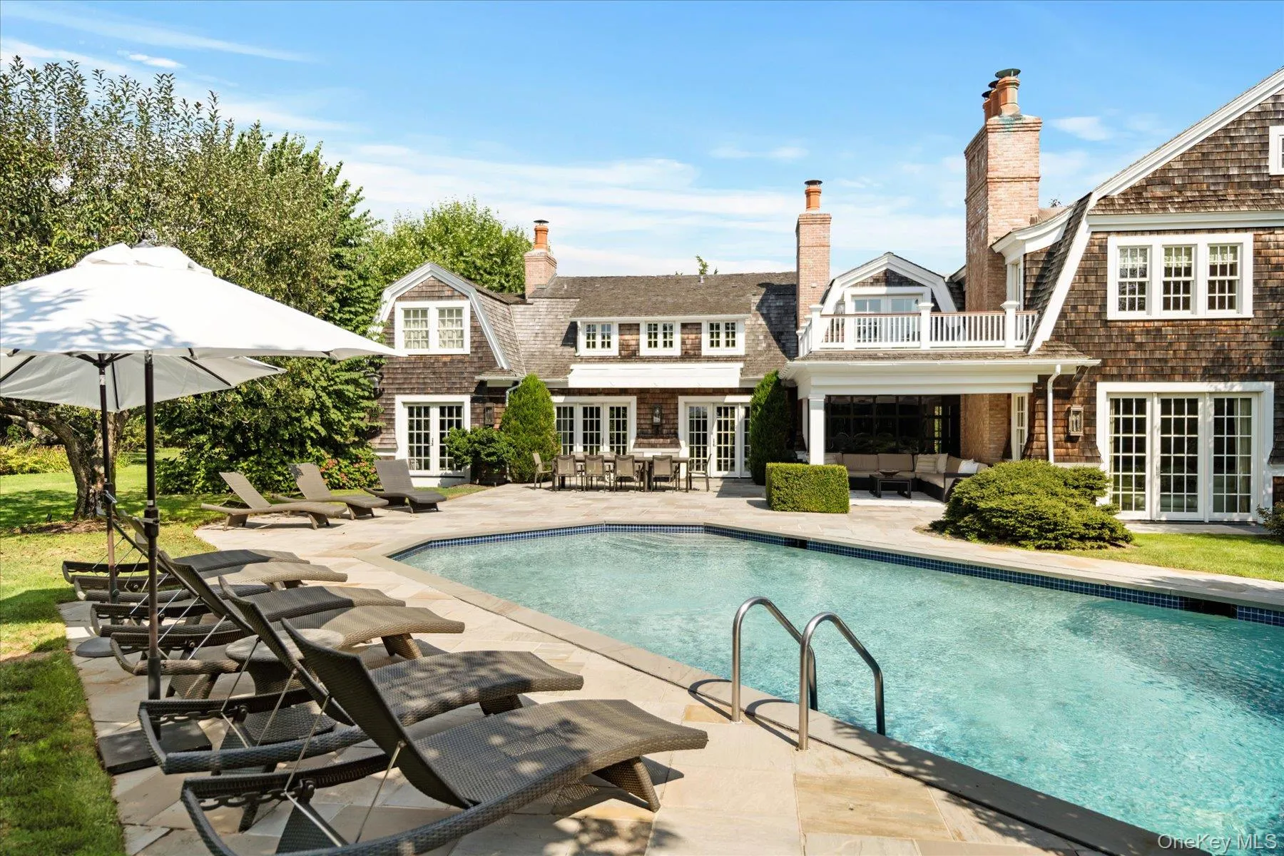 Outdoor pool featuring french doors, an outdoor living space, a patio, and a balcony Outdoor pool featuring french doors, an outdoor living space, a patio, and a balcony