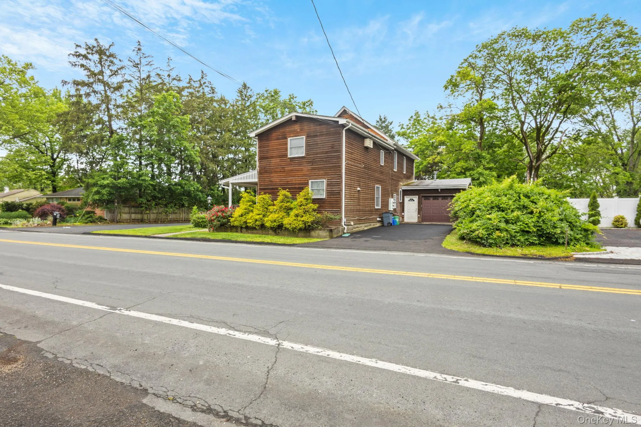 View of property exterior featuring a garage and driveway View of property exterior featuring a garage and driveway
