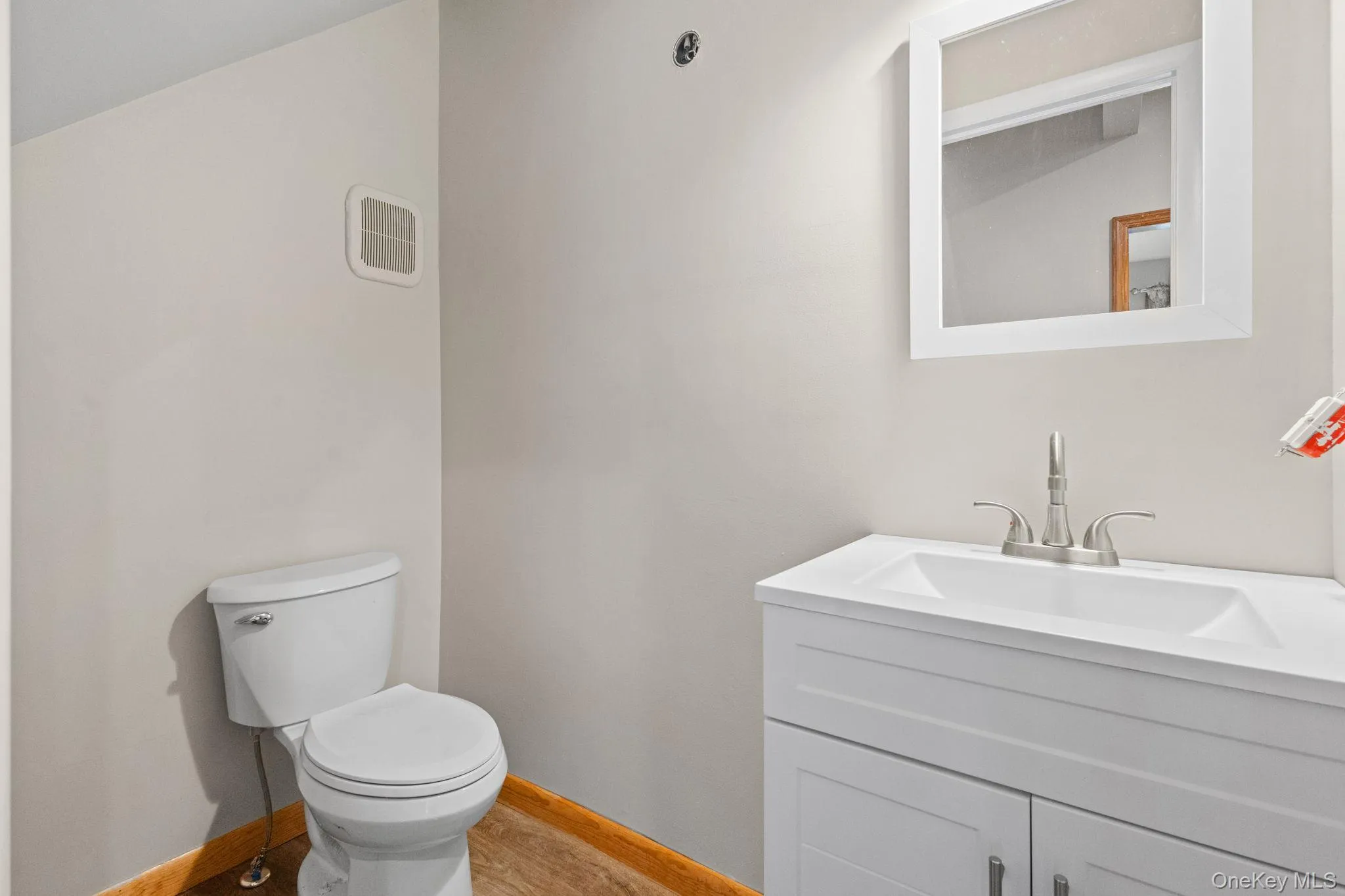 Bathroom with toilet, baseboards, and vanity Bathroom with toilet, baseboards, and vanity