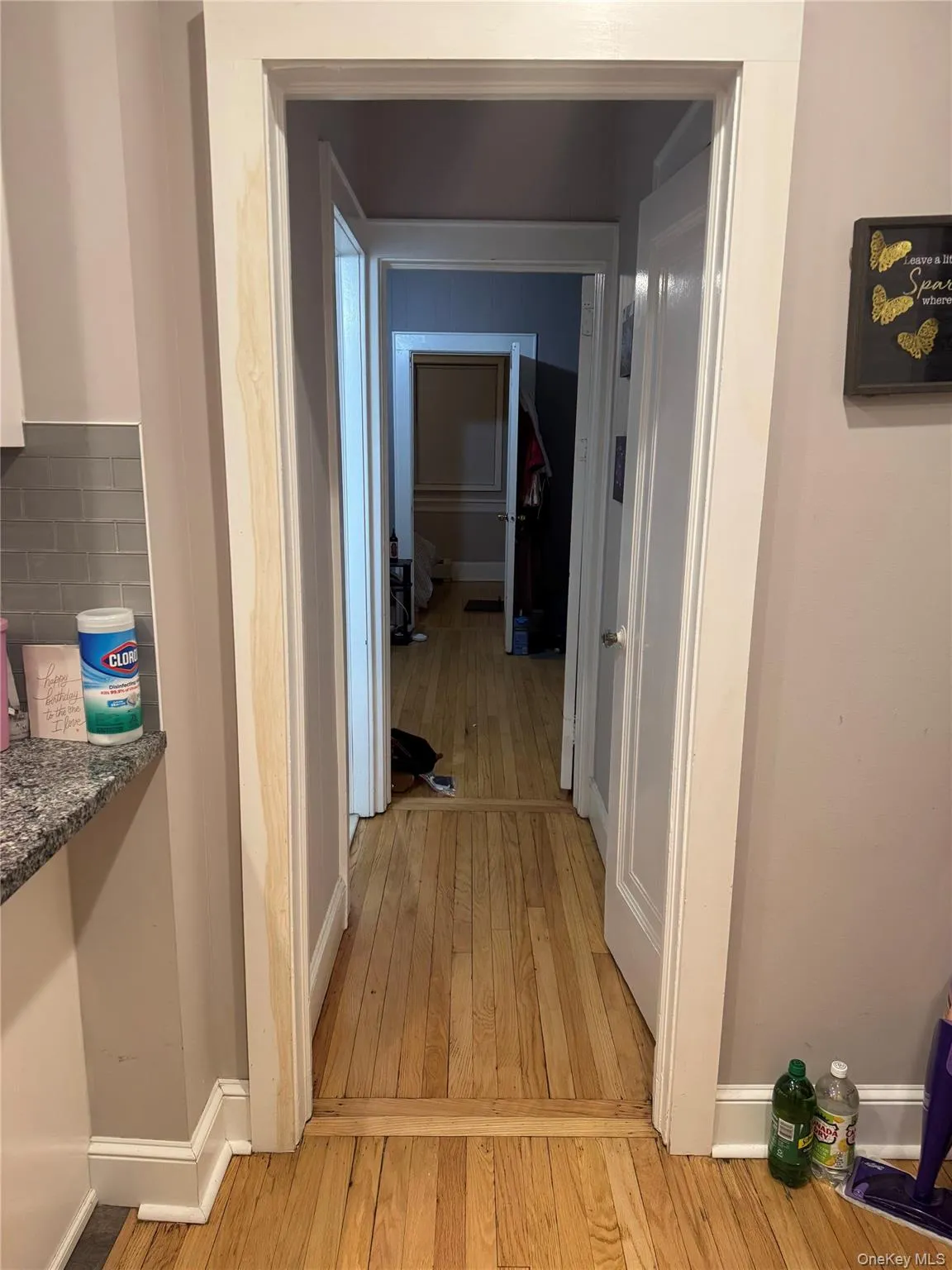 Hallway featuring light wood-style flooring and baseboards Hallway featuring light wood-style flooring and baseboards