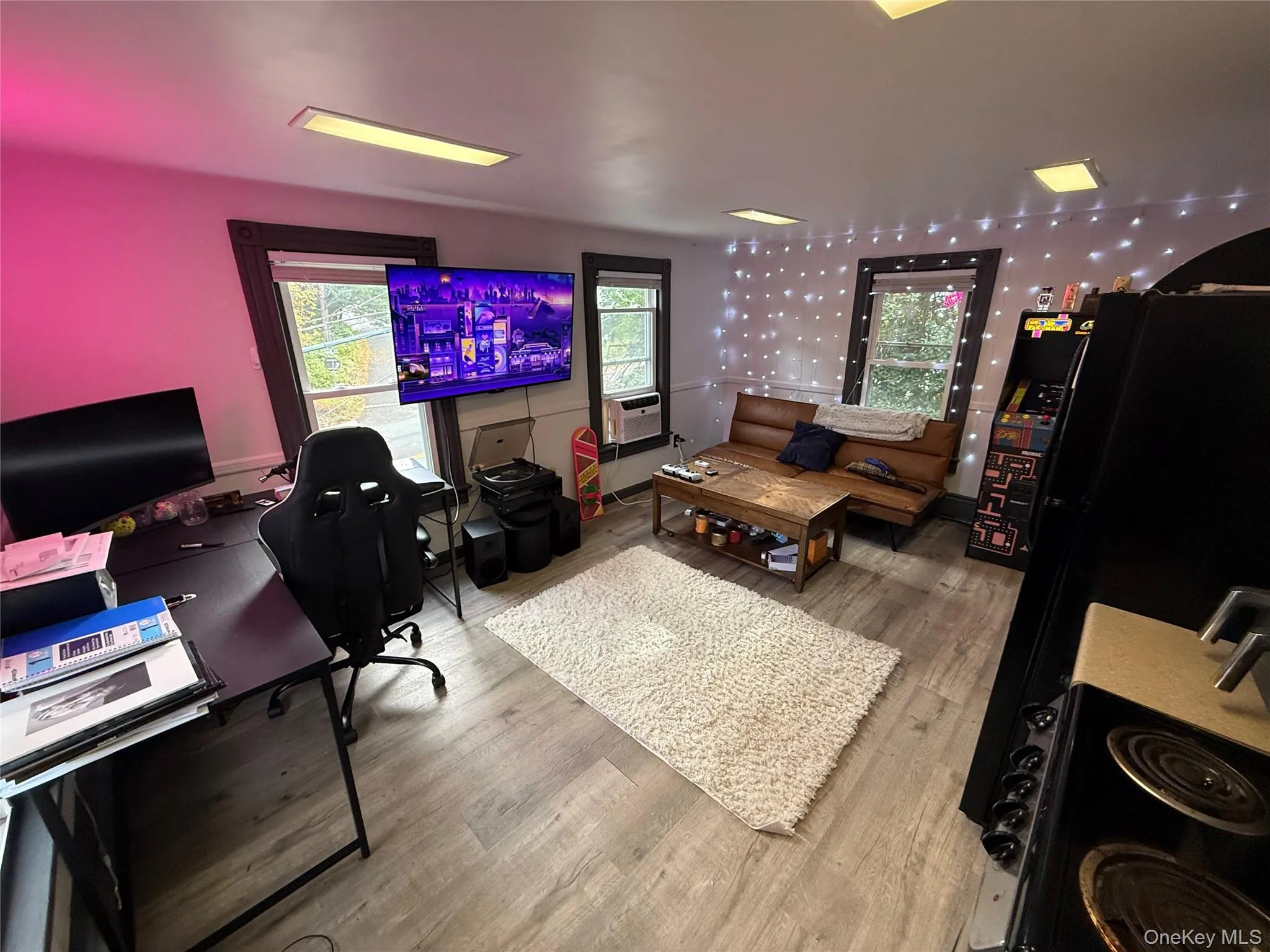 Office with plenty of natural light, wood finished floors, and cooling unit Office with plenty of natural light, wood finished floors, and cooling unit
