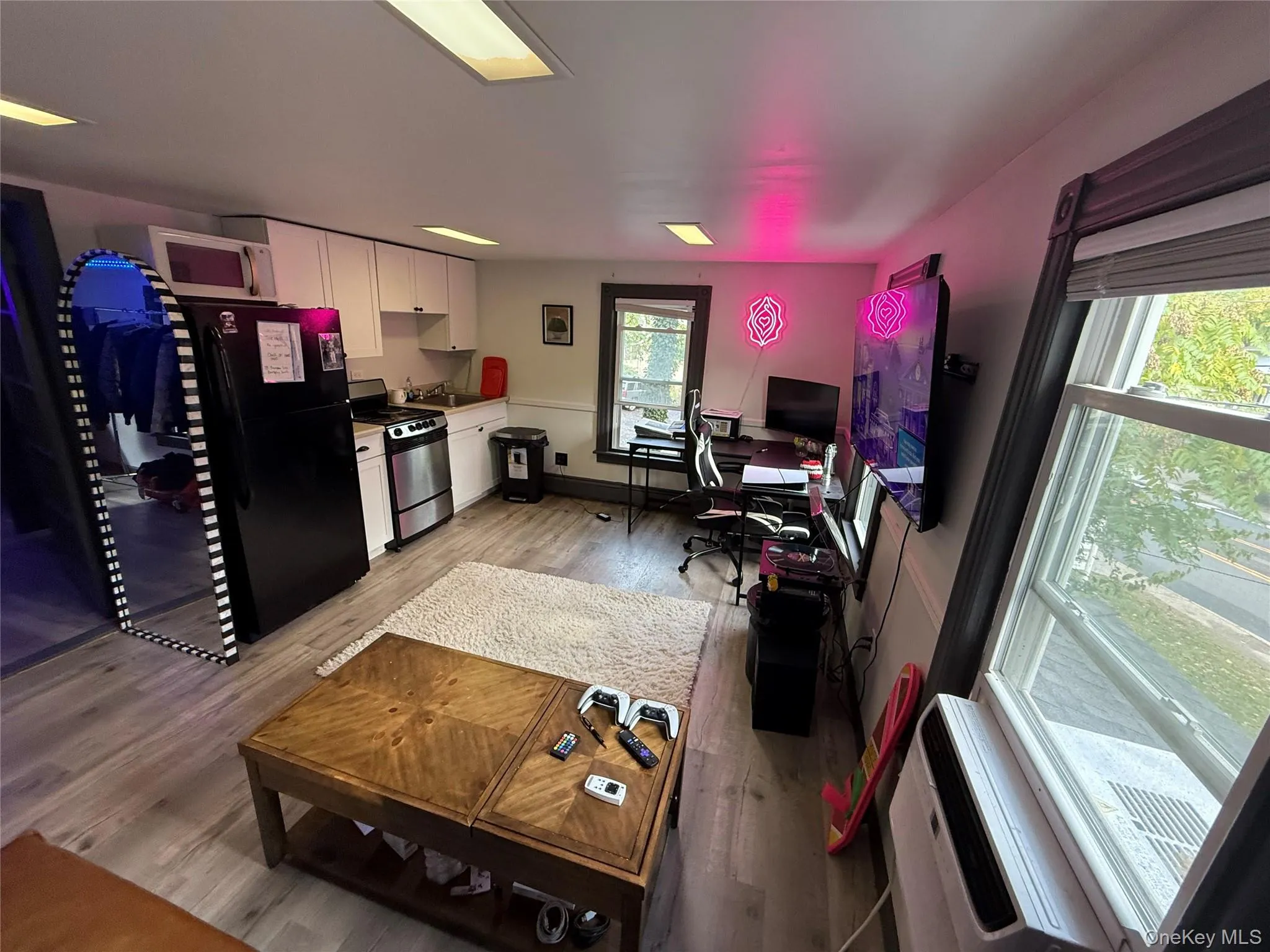 Living room featuring an office area and light wood-style floors Living room featuring an office area and light wood-style floors