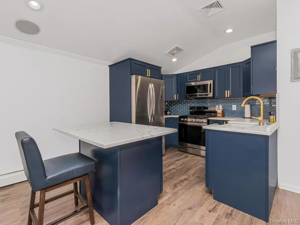 Open concept renovated kitchen with SS appliances, Quartz countertops and tile backsplash Open concept renovated kitchen with SS appliances, Quartz countertops and tile backsplash