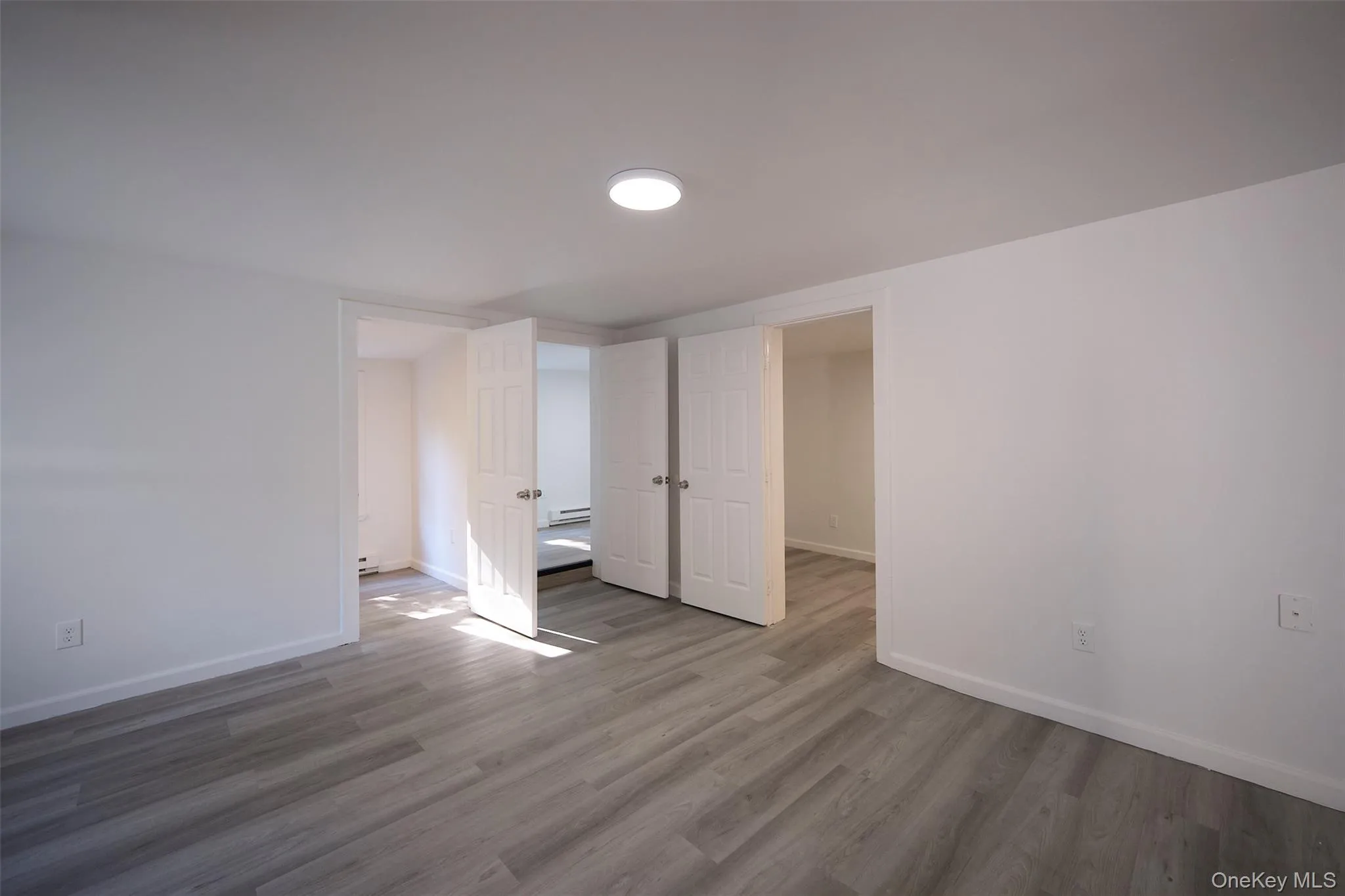 Unfurnished bedroom featuring baseboards and wood finished floors Unfurnished bedroom featuring baseboards and wood finished floors