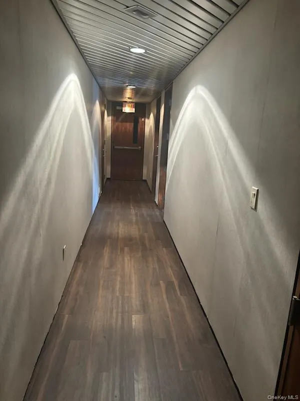 Hall featuring dark wood finished floors Hall featuring dark wood finished floors