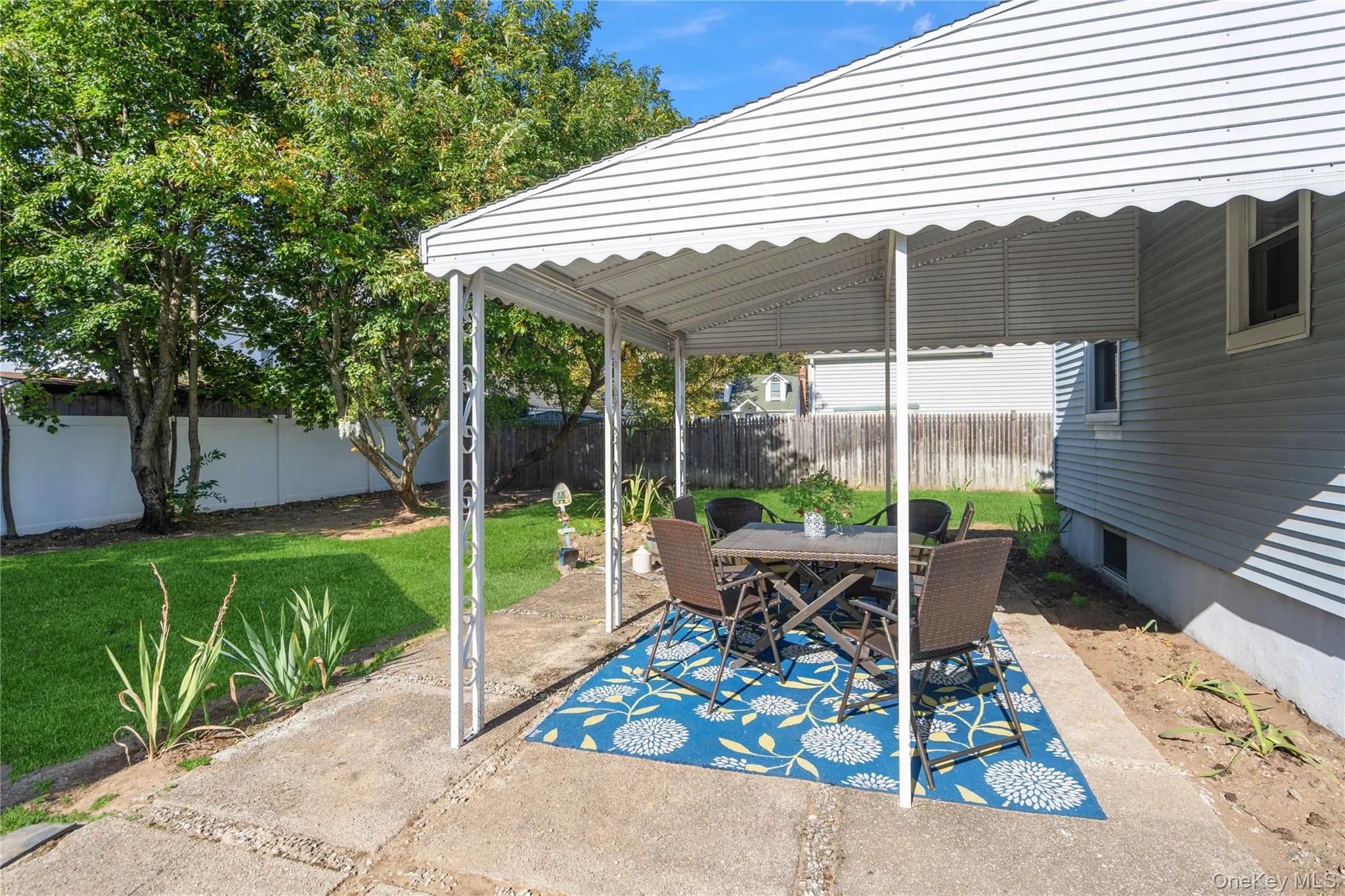 Fenced backyard featuring a patio area and outdoor dining space Fenced backyard featuring a patio area and outdoor dining space