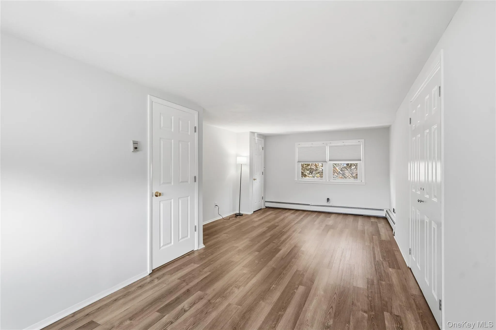 Unfurnished room featuring wood finished floors and baseboards Unfurnished room featuring wood finished floors and baseboards