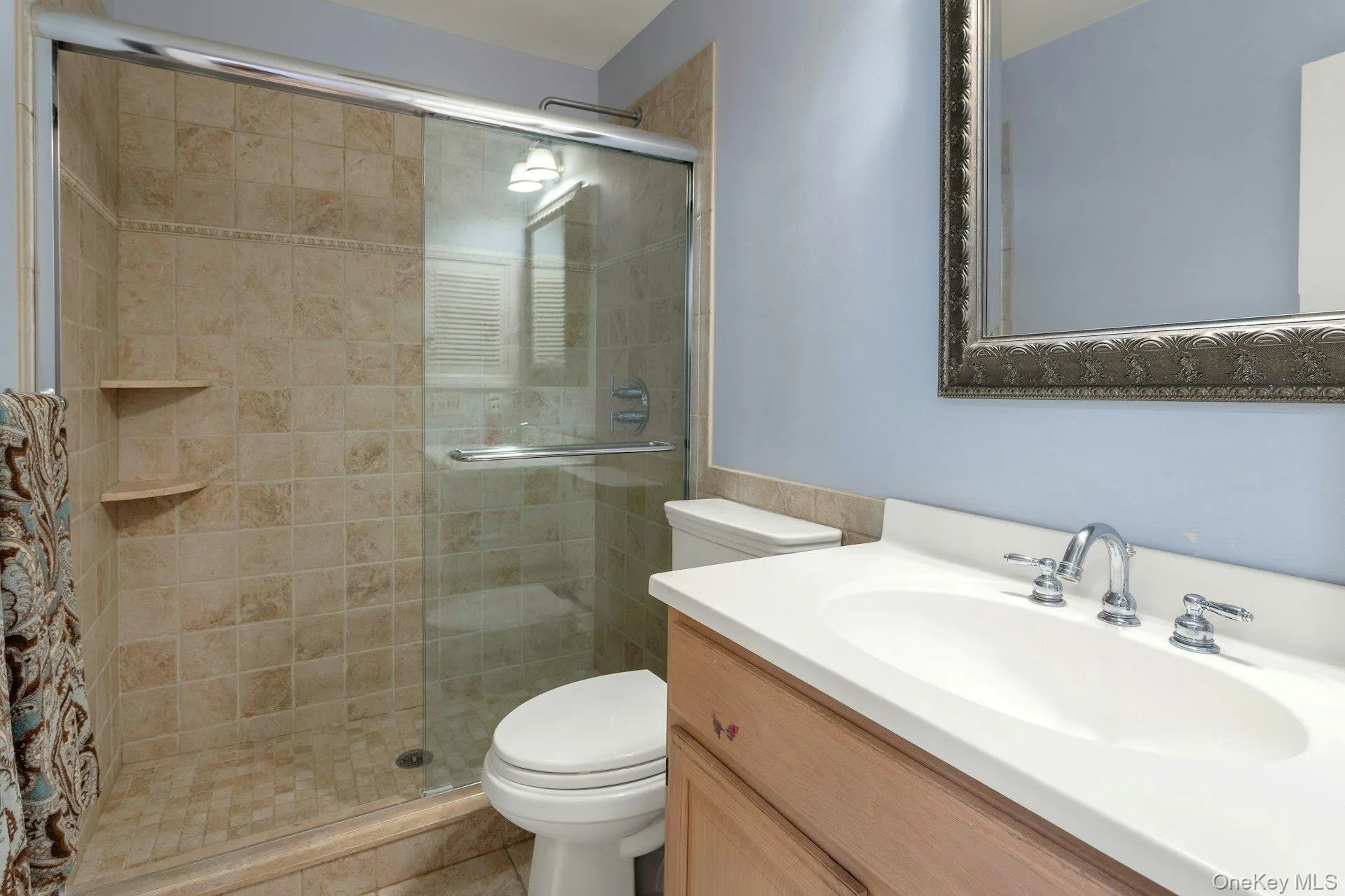 Bathroom featuring vanity and a shower stall Bathroom featuring vanity and a shower stall