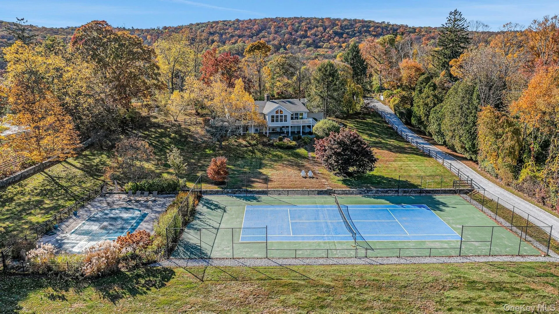 Aerial view of property and surrounding area with a forest Aerial view of property and surrounding area with a forest
