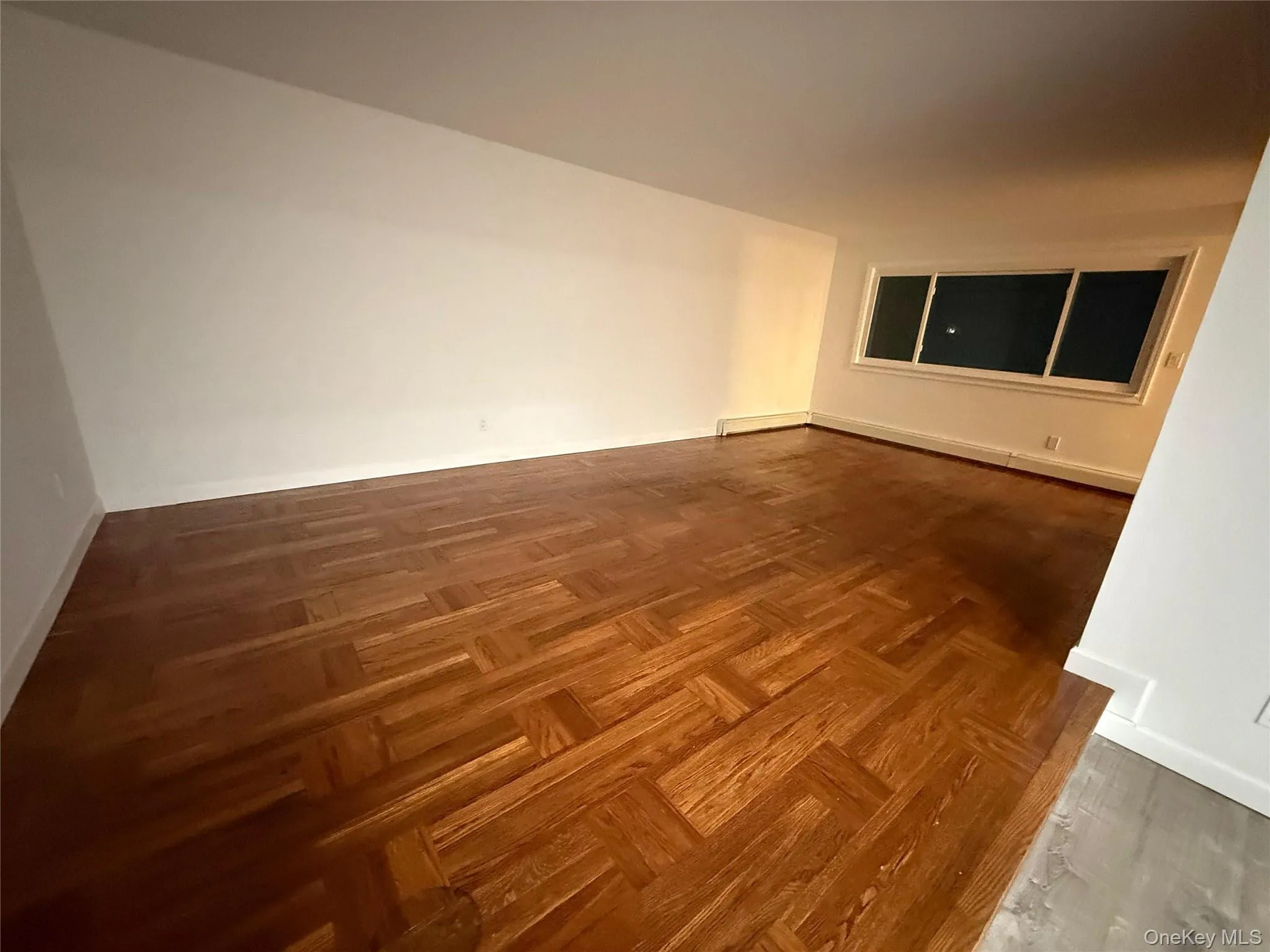 Empty room with baseboards and a baseboard heating unit Empty room with baseboards and a baseboard heating unit