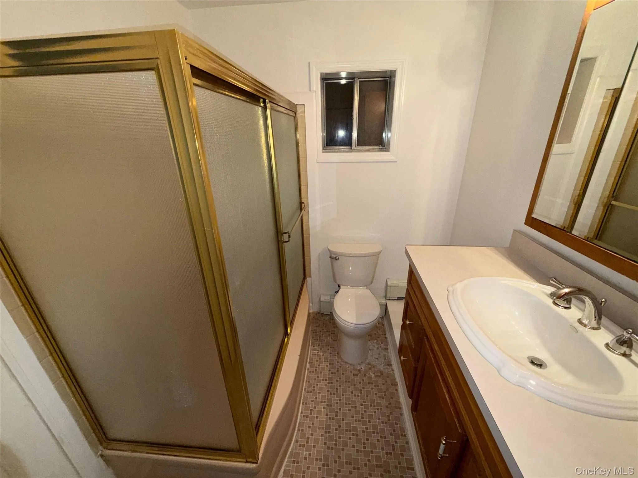 Bathroom featuring vanity, a stall shower, and light tile patterned floors Bathroom featuring vanity, a stall shower, and light tile patterned floors
