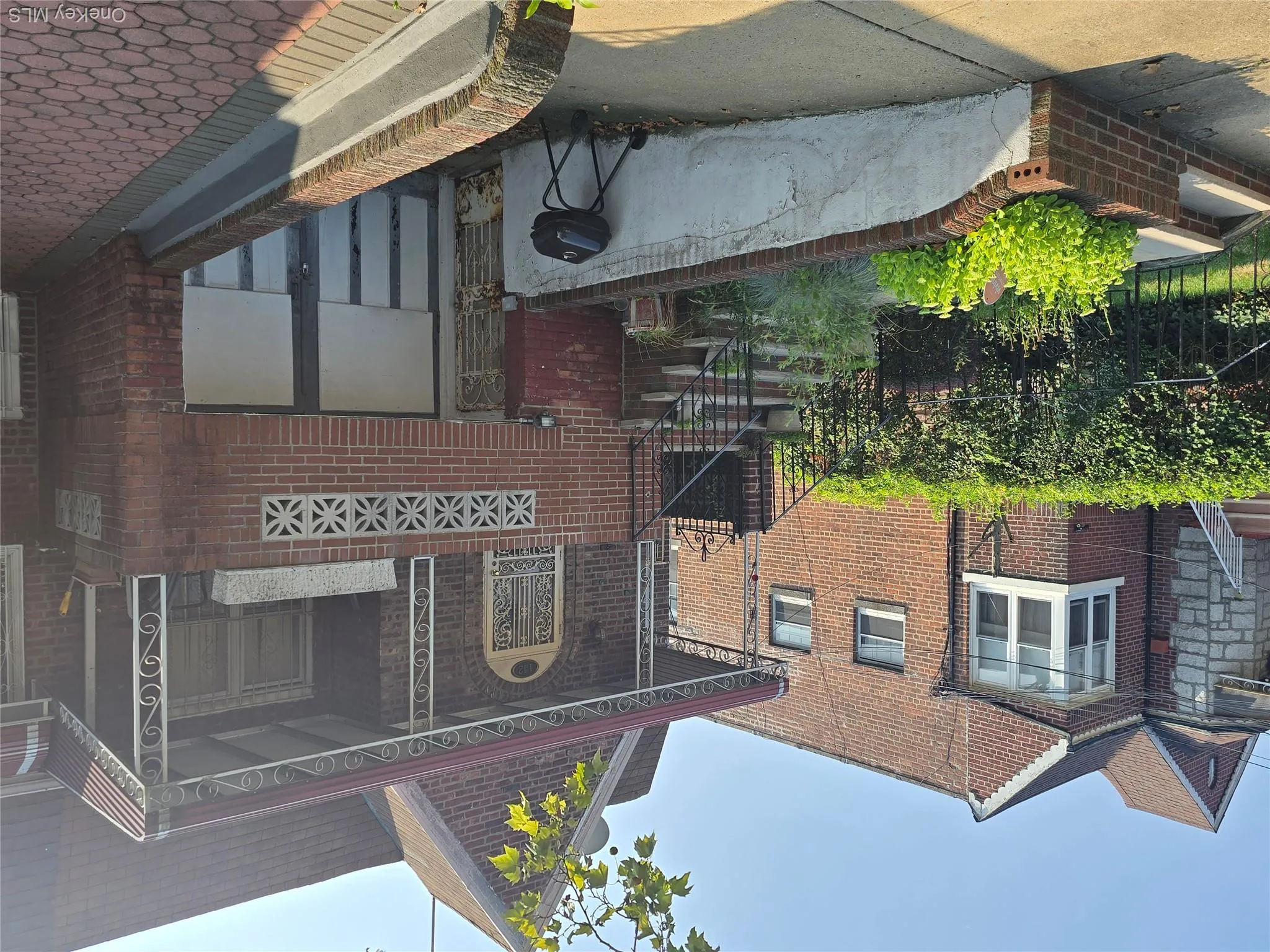 View of front of home with brick siding and a porch View of front of home with brick siding and a porch