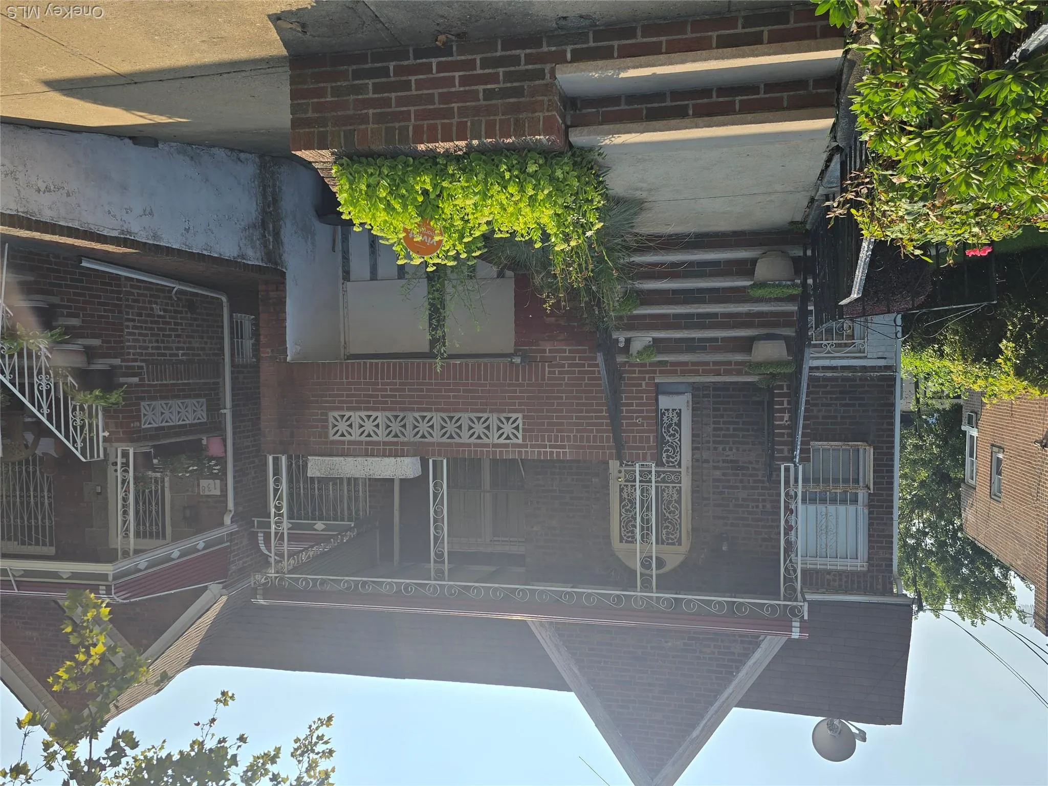 View of front of house featuring covered porch, brick siding, and stairs View of front of house featuring covered porch, brick siding, and stairs