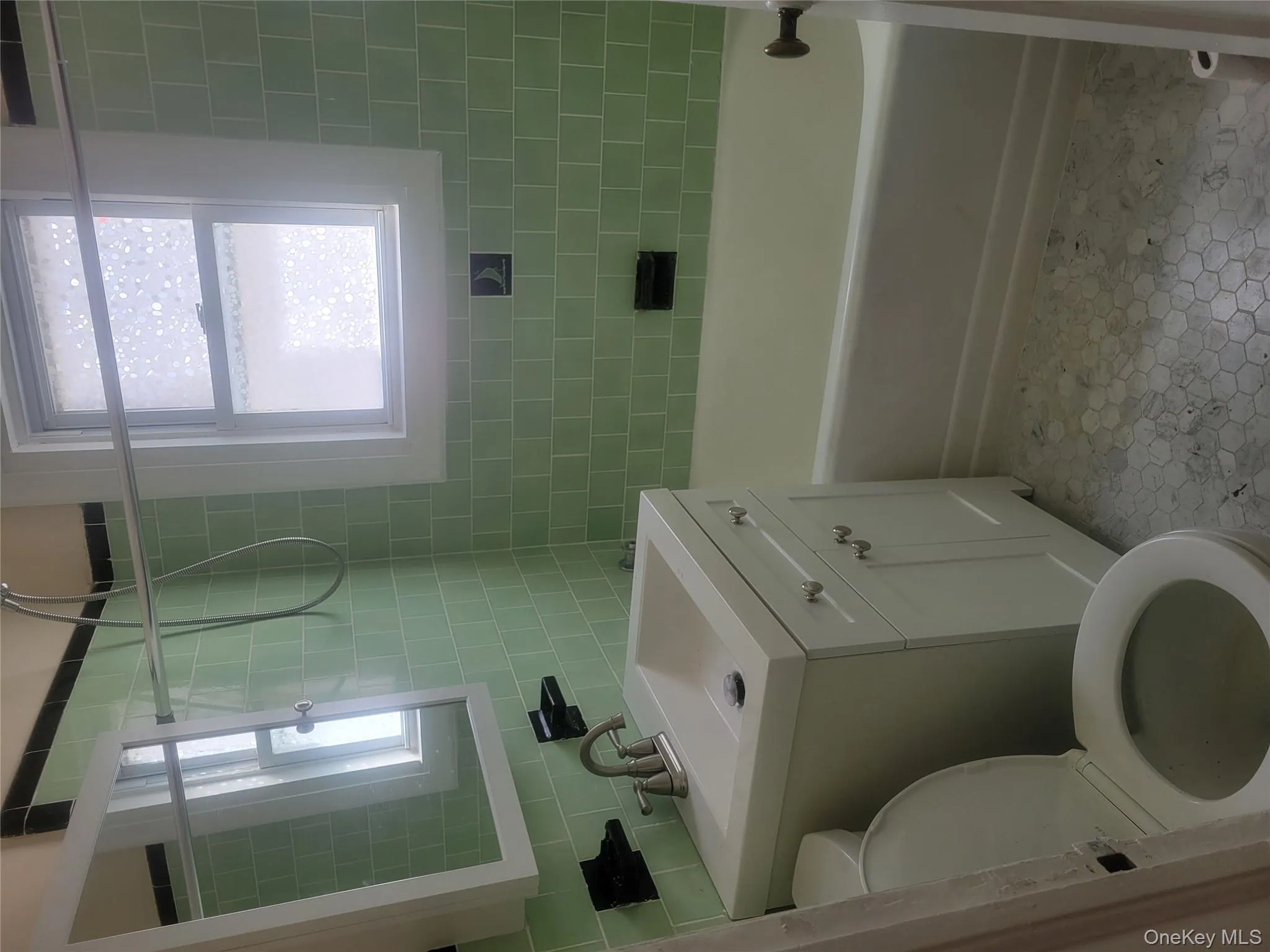 Full bath with vanity, plenty of natural light, shower / bathtub combination, tile walls, and tasteful backsplash Full bath with vanity, plenty of natural light, shower / bathtub combination, tile walls, and tasteful backsplash