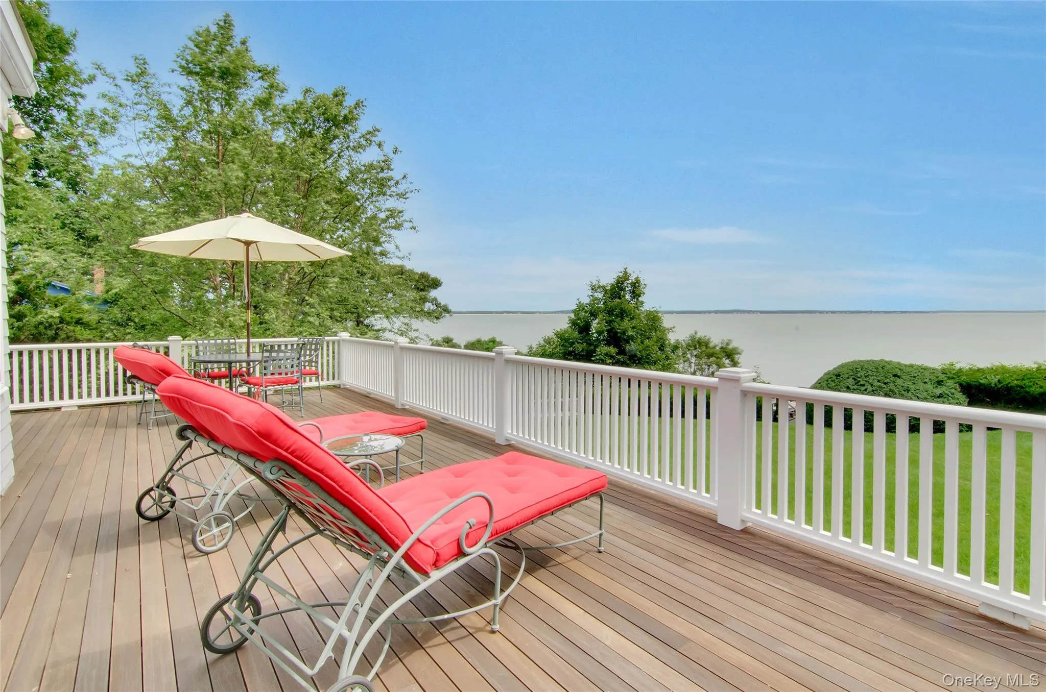Wooden deck with a water view and outdoor dining area Wooden deck with a water view and outdoor dining area