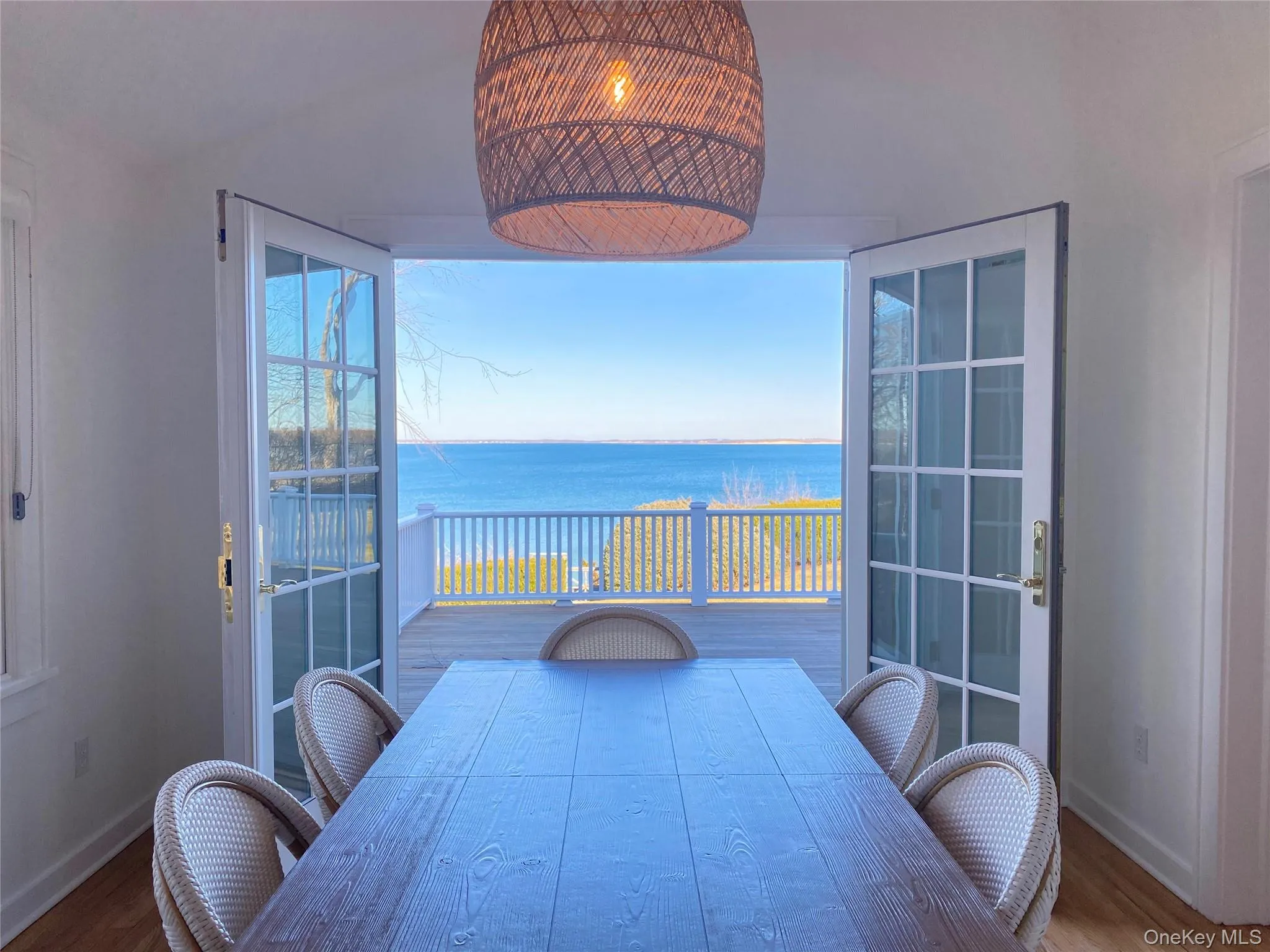Dining area with a water view and wood finished floors Dining area with a water view and wood finished floors