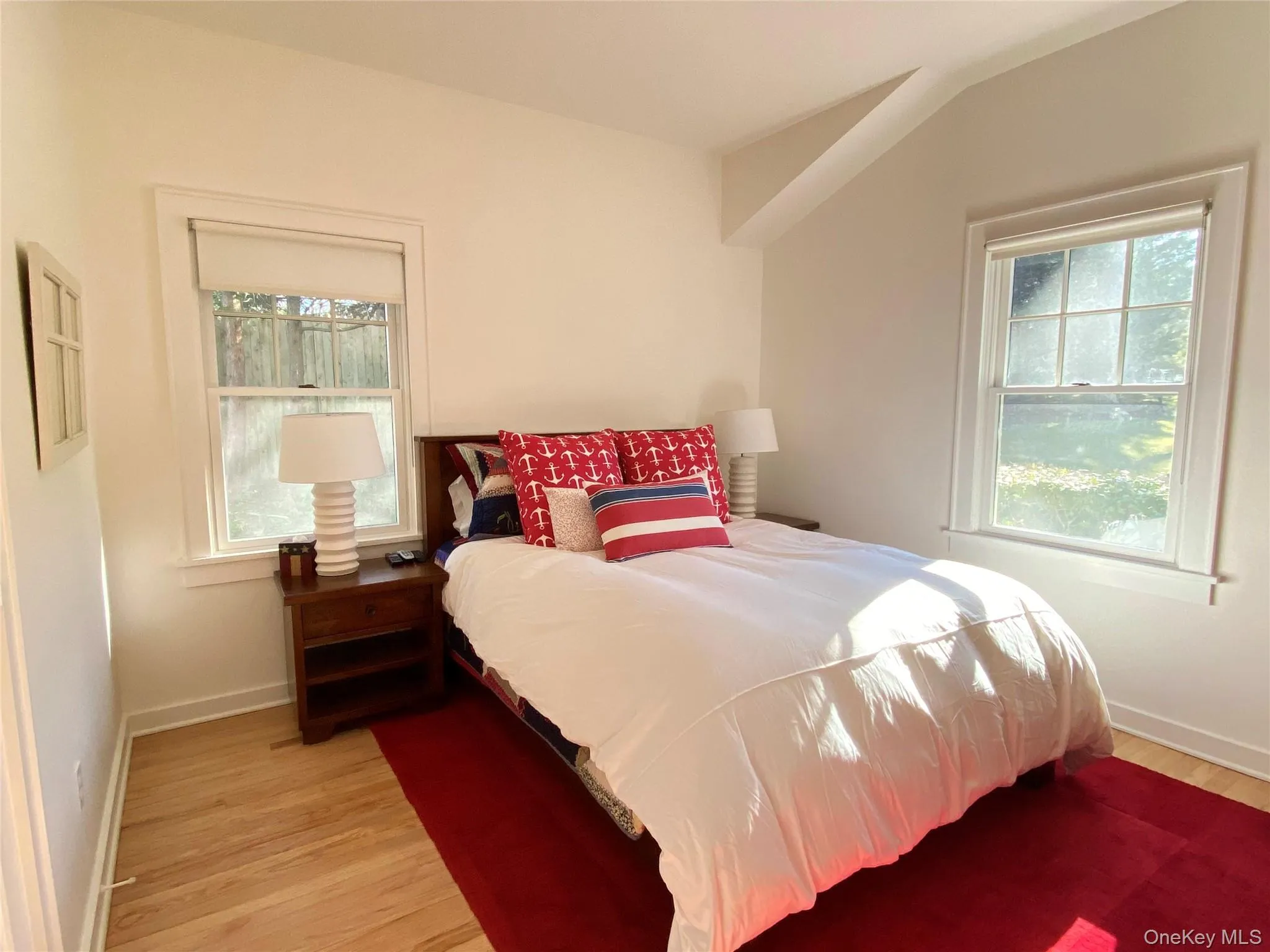 1st Floor Bedroom featuring light wood-style flooring and multiple windows 1st Floor Bedroom featuring light wood-style flooring and multiple windows