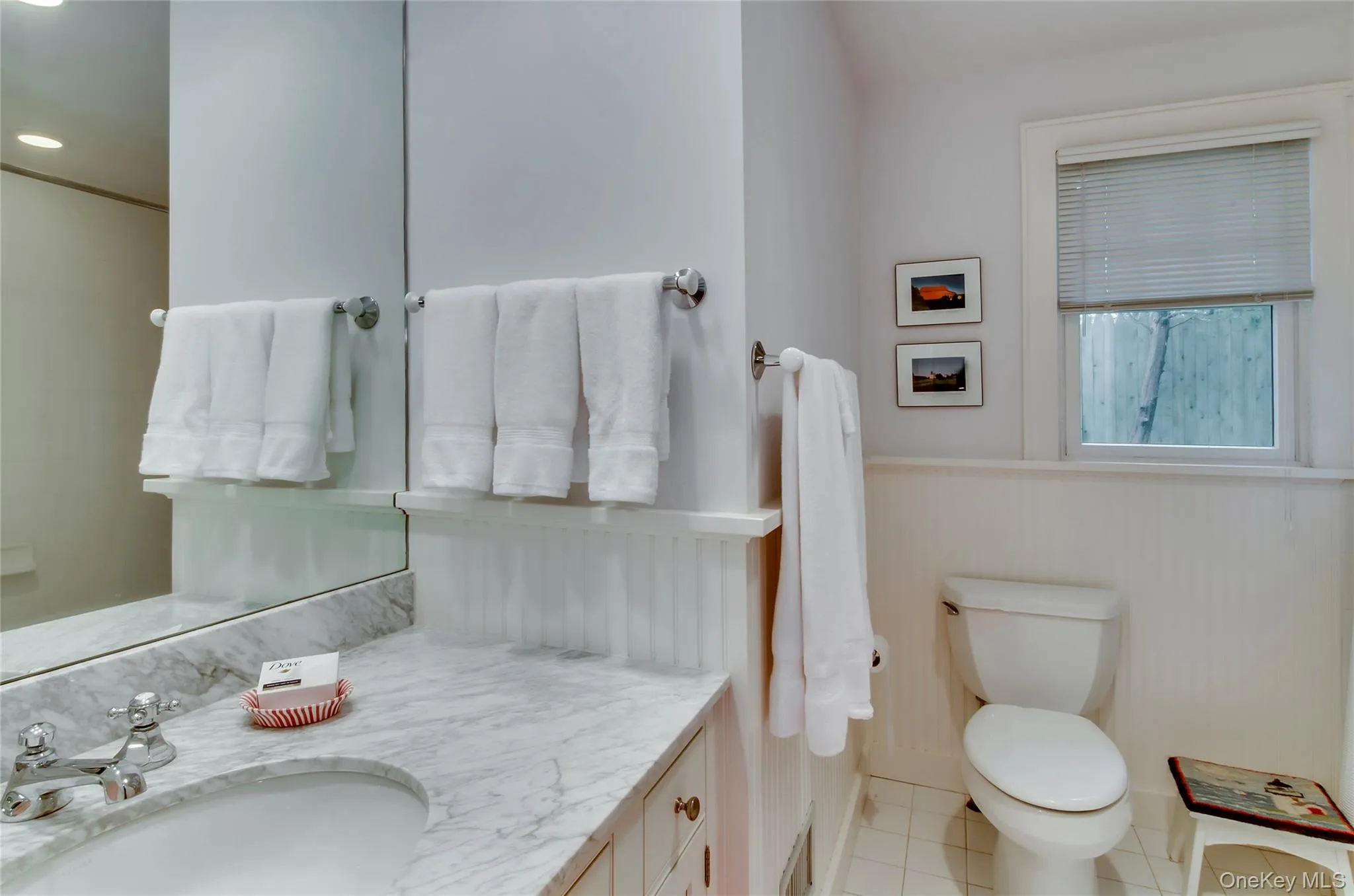 Bathroom featuring vanity, light tile patterned floors, a wainscoted wall, and recessed lighting Bathroom featuring vanity, light tile patterned floors, a wainscoted wall, and recessed lighting