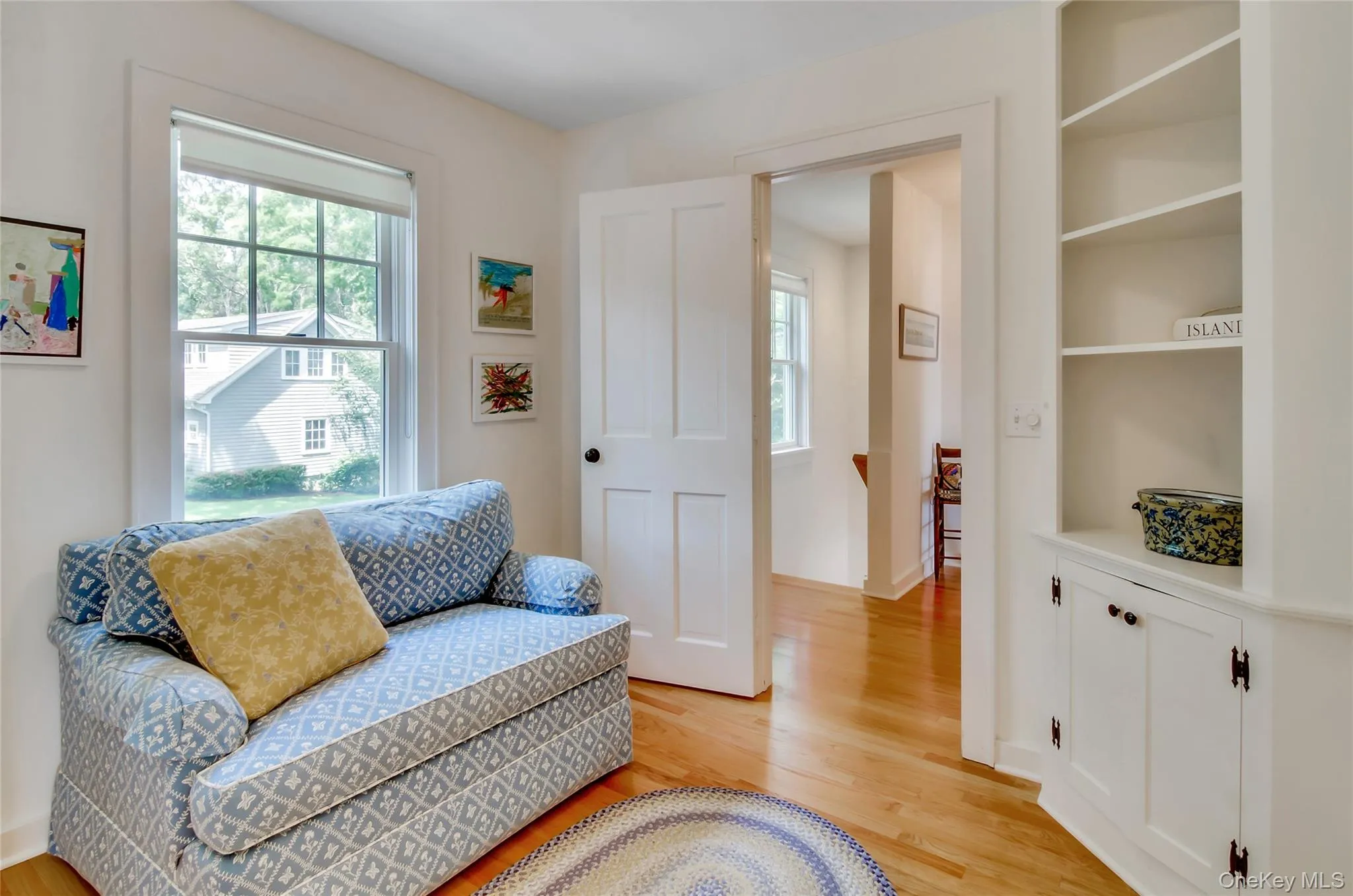 Sitting room featuring light wood finished floors and healthy amount of natural light Sitting room featuring light wood finished floors and healthy amount of natural light