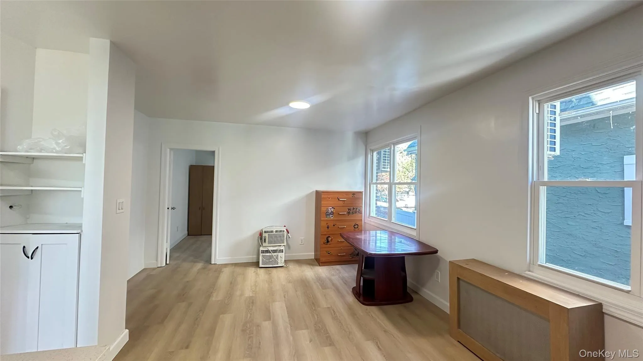 Additional living space with radiator and light wood-type flooring Additional living space with radiator and light wood-type flooring